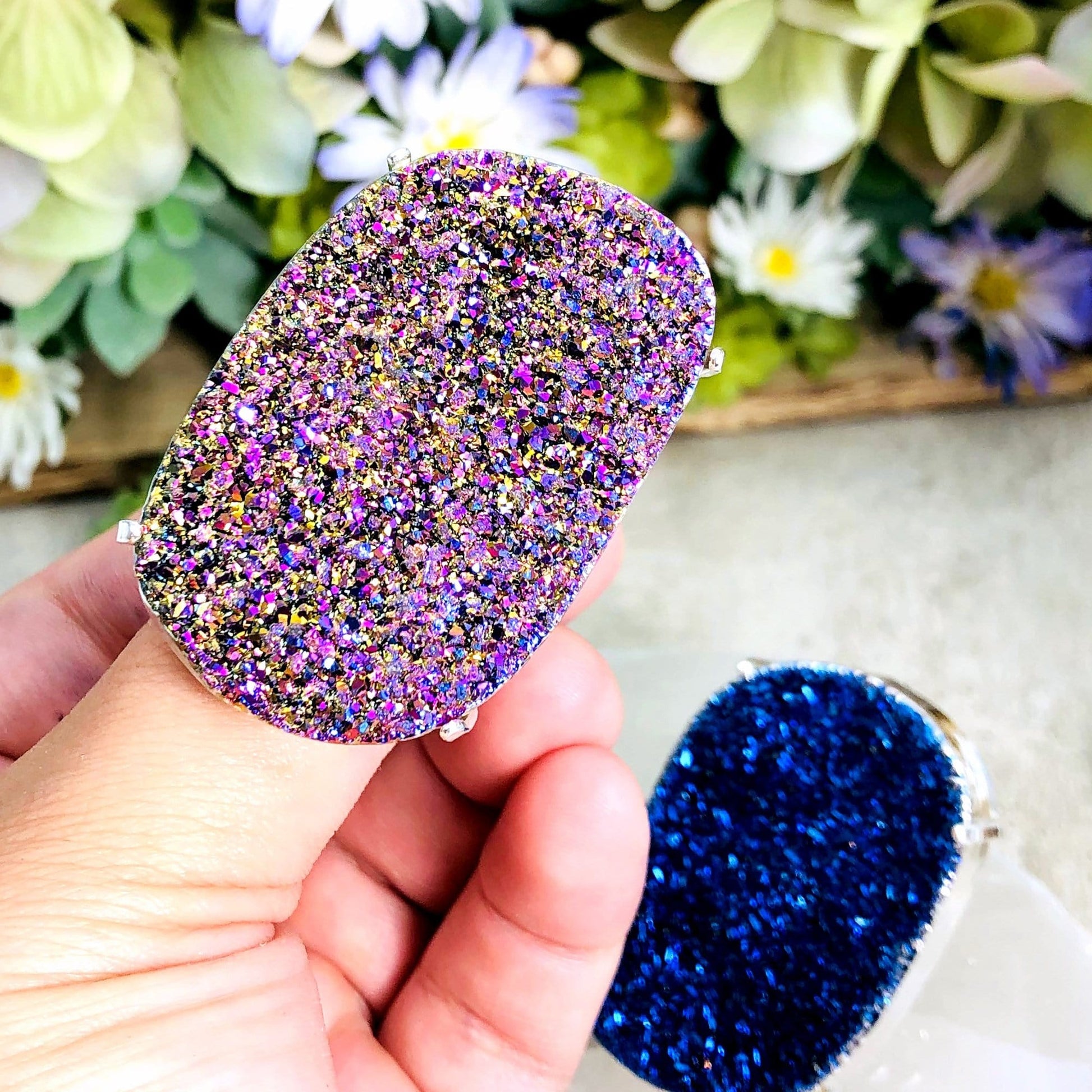 mystic rainbow ring displayed in hand to show size reference