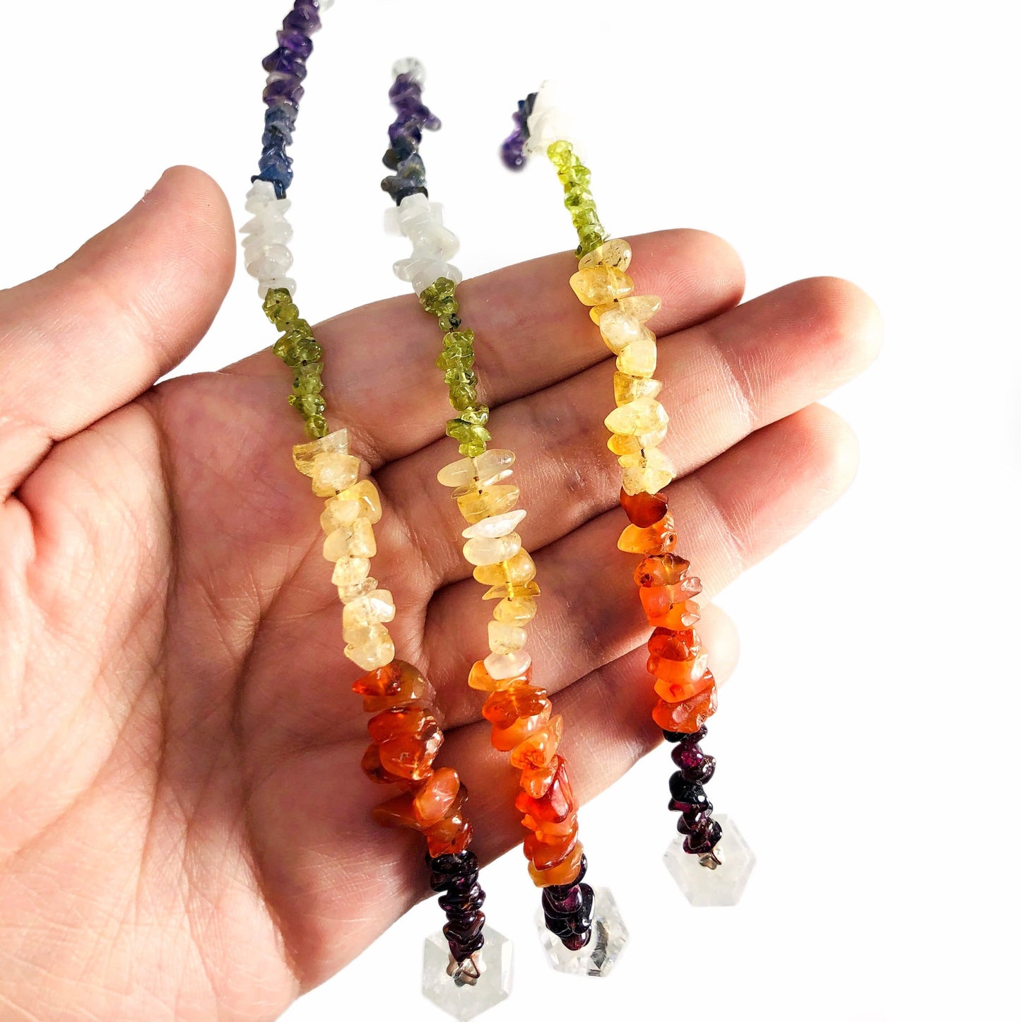 Crystal Quartz Pendulum with Chakra Beads  - close up of beads in a hand
