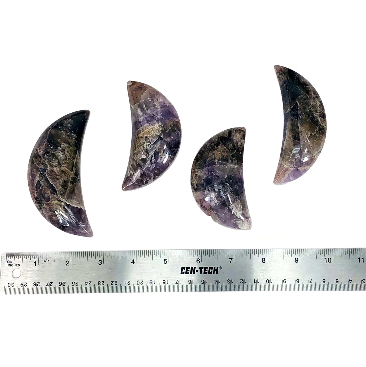 four seven minerals in one polished moons with ruler for size reference