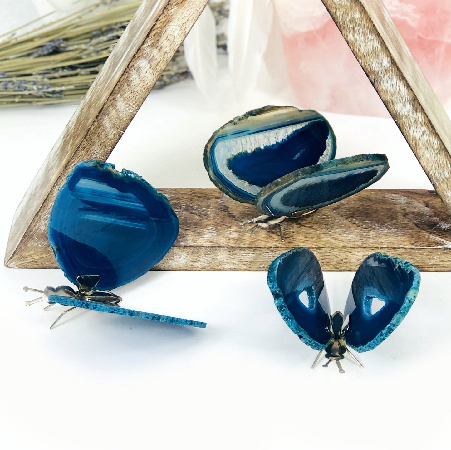 Teal Agate Druzy Butterfly Stands in an alter with crystals and flowers.