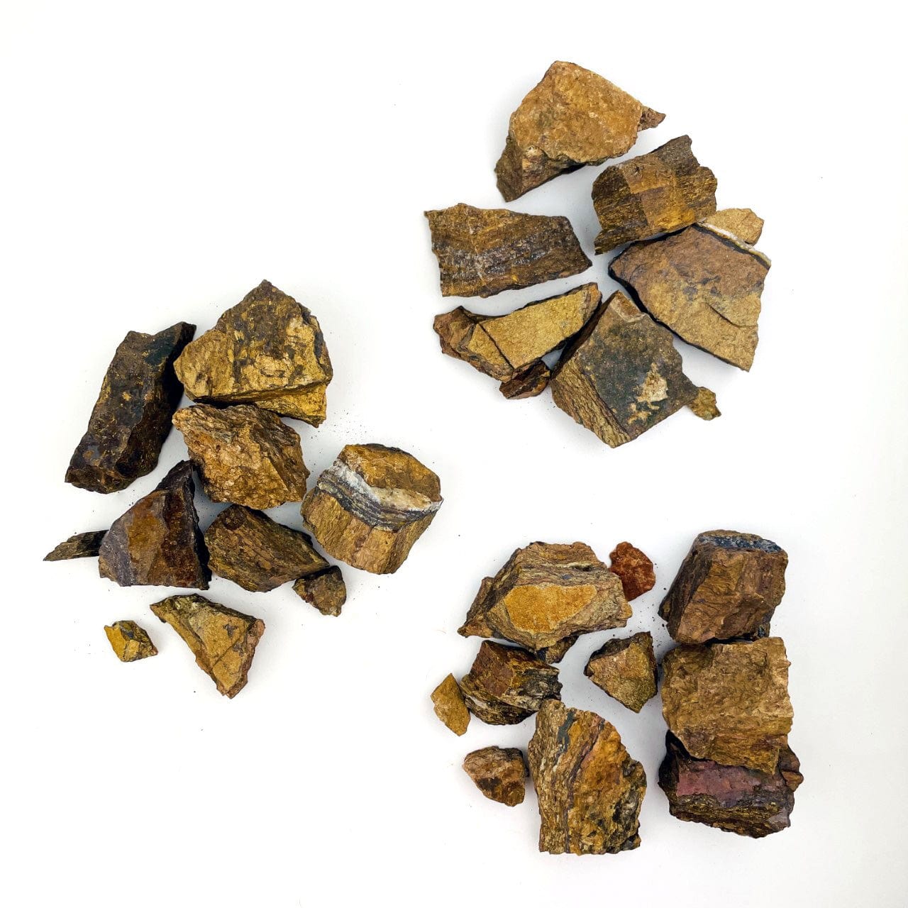 3 piles of 1 pound each of Tigers Eye Rough stones