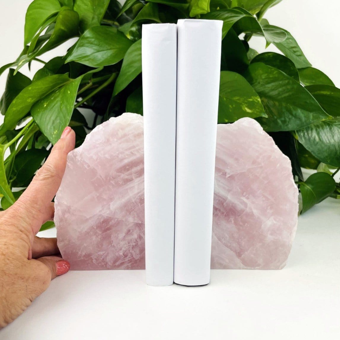 Rose Quartz Bookend Set - a hand near them