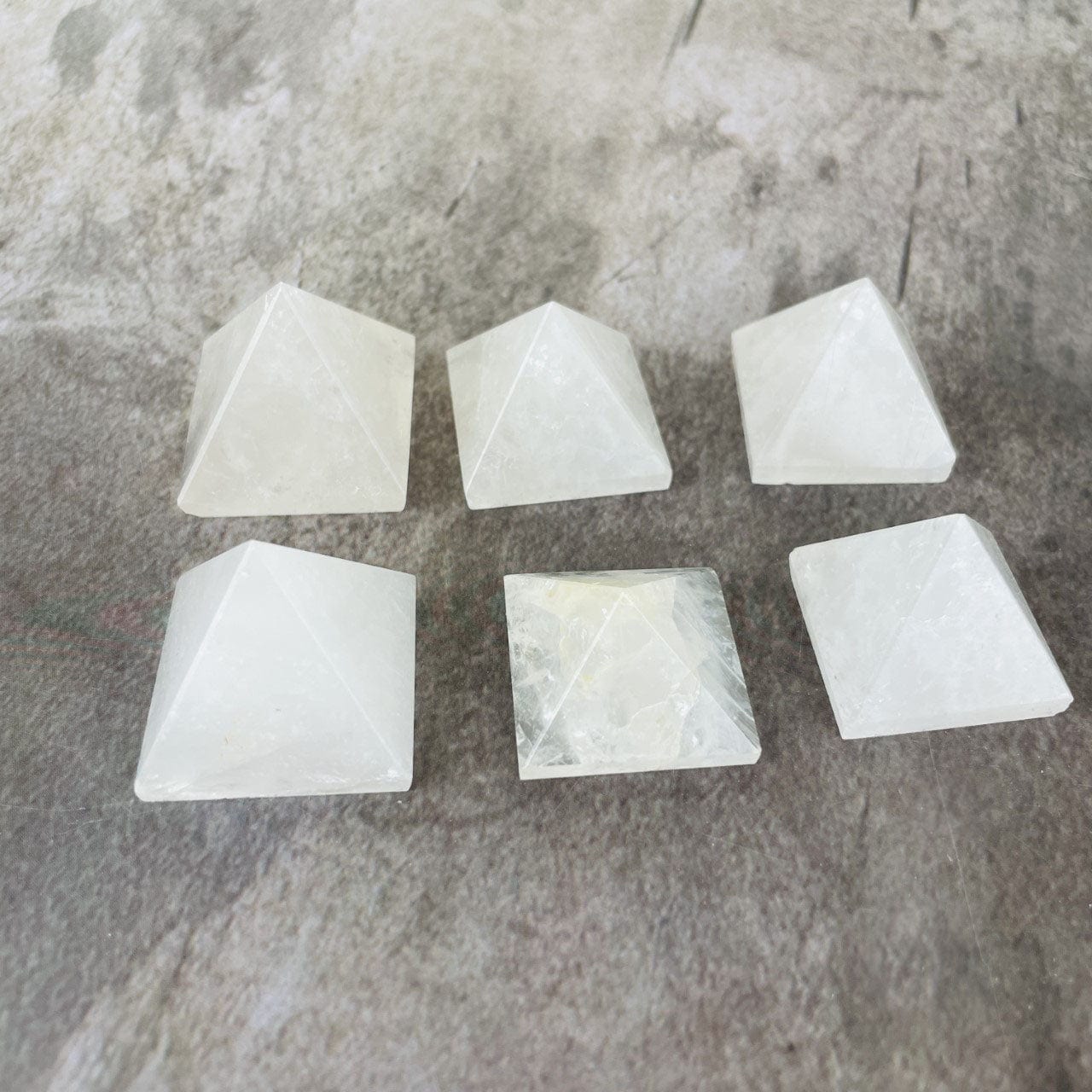 6 Crystal Quartz Pyramids on a table