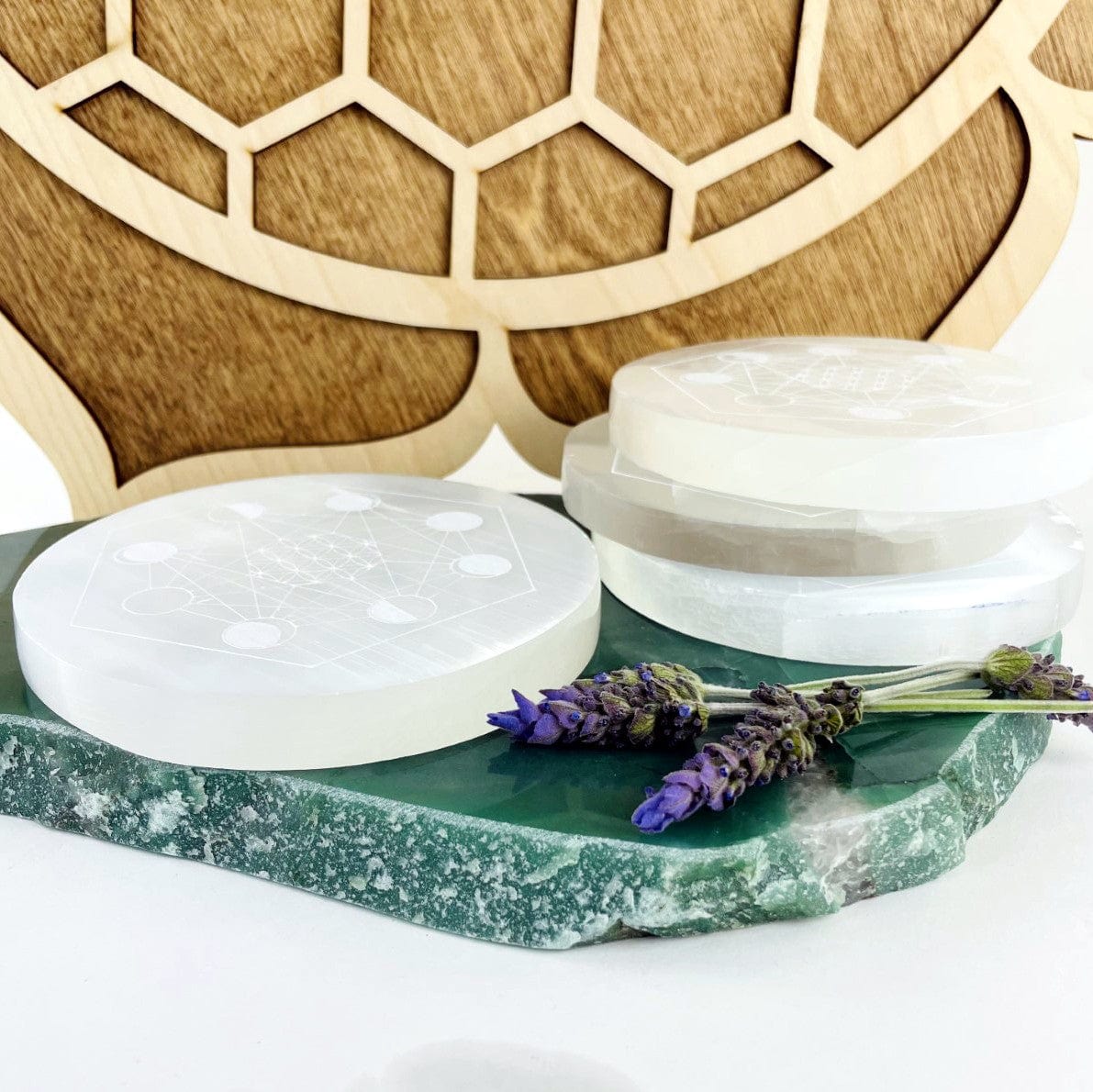 side view of selenite moon phase engraved charging plate for thickness