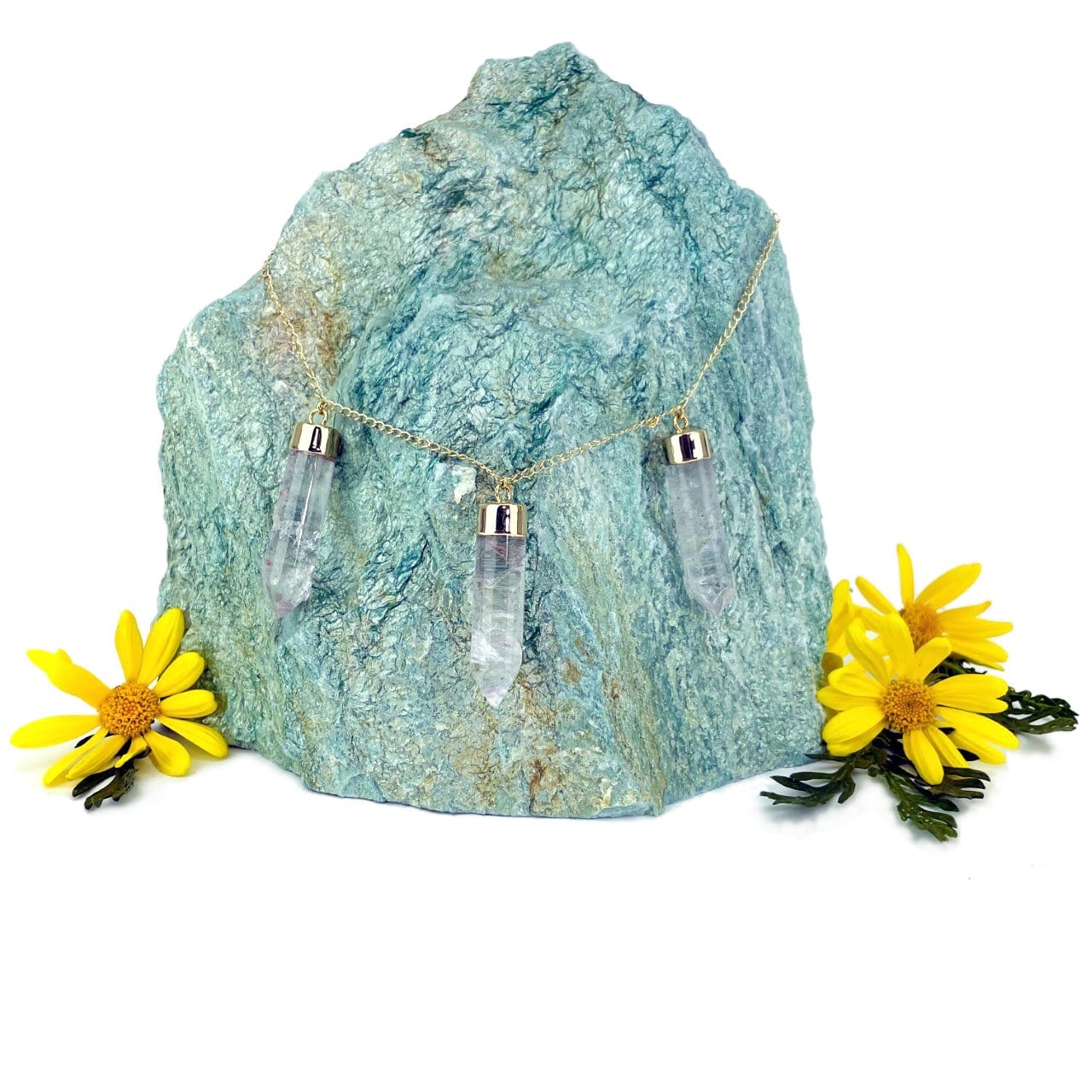triple point necklace in gold displayed on large gemstone (not included)