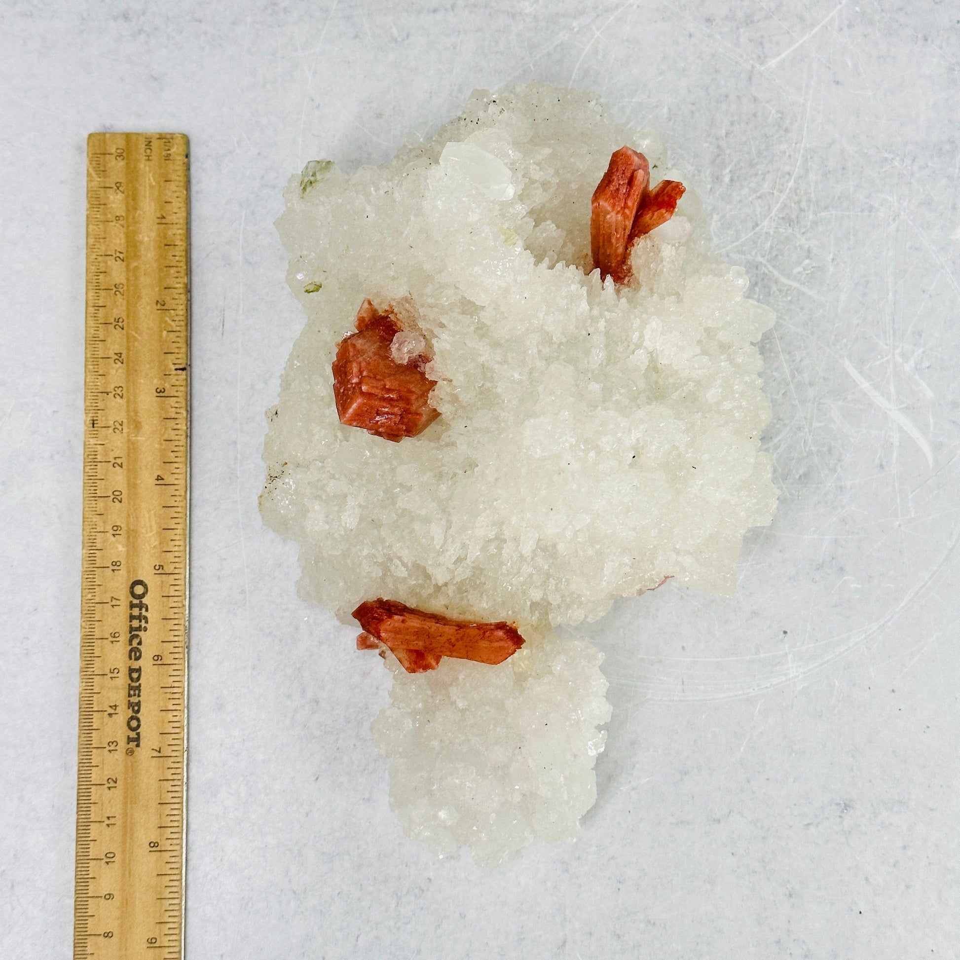 apophyllite with stilbite cluster next to a ruler for size reference