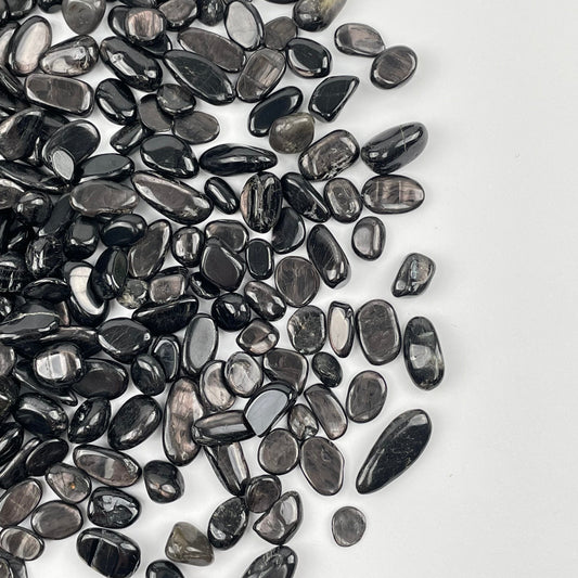 Hypersthene Tumbled Chips displayed to show the differences in the sizes and color shades 