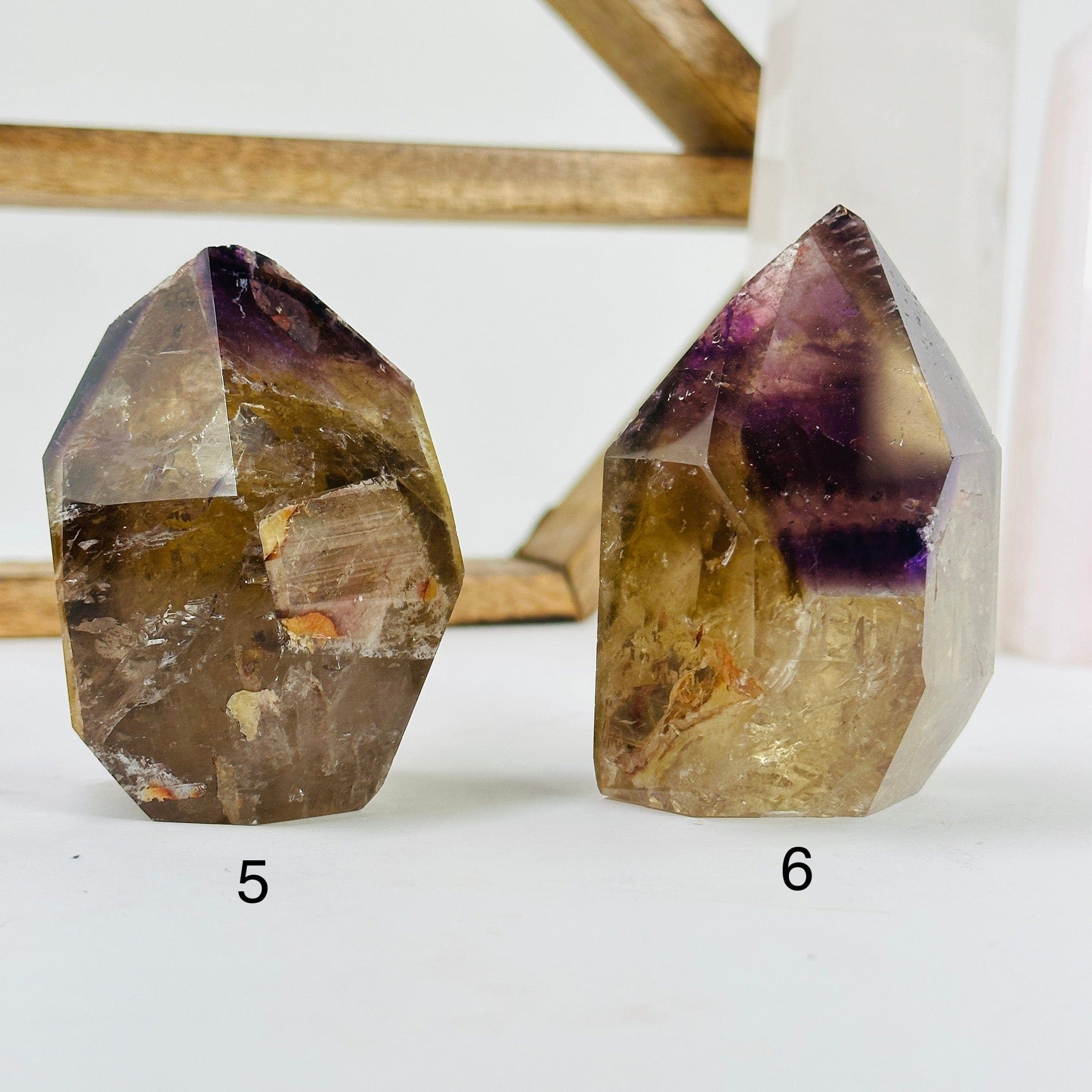 ametrine polished points with decorations in the background
