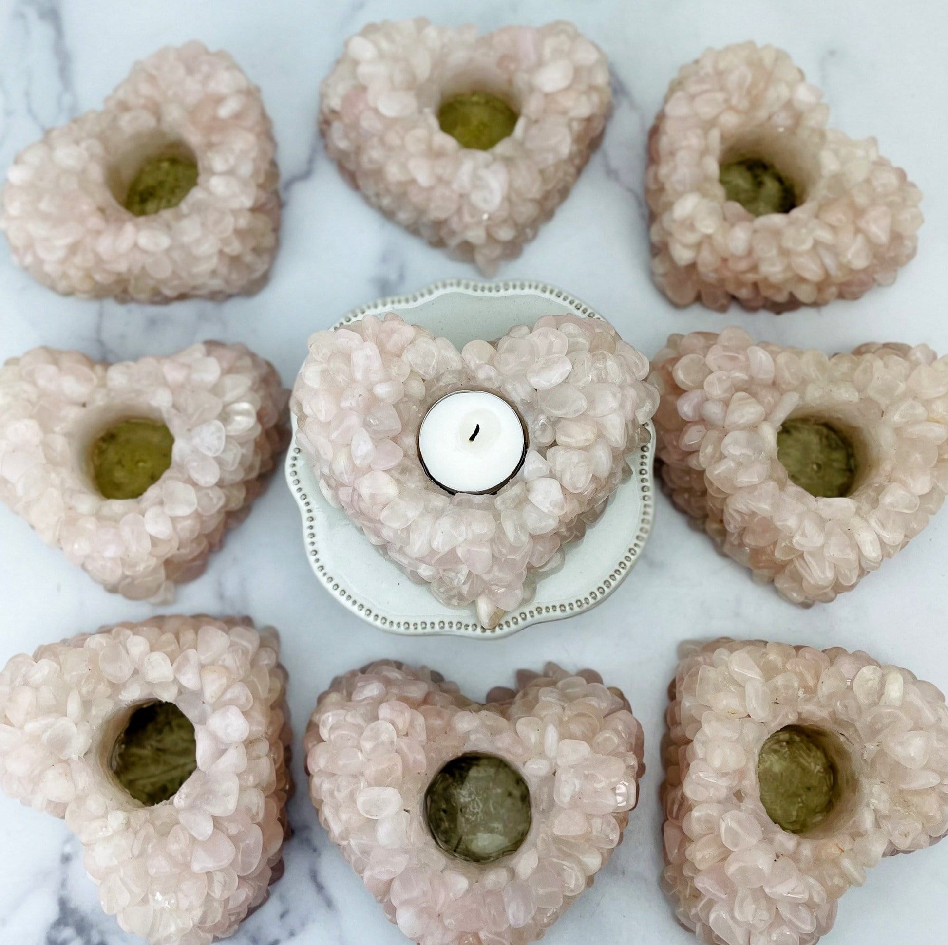9 Rose Quartz Tumbled stone Heart Candle Holders arranged on marble background