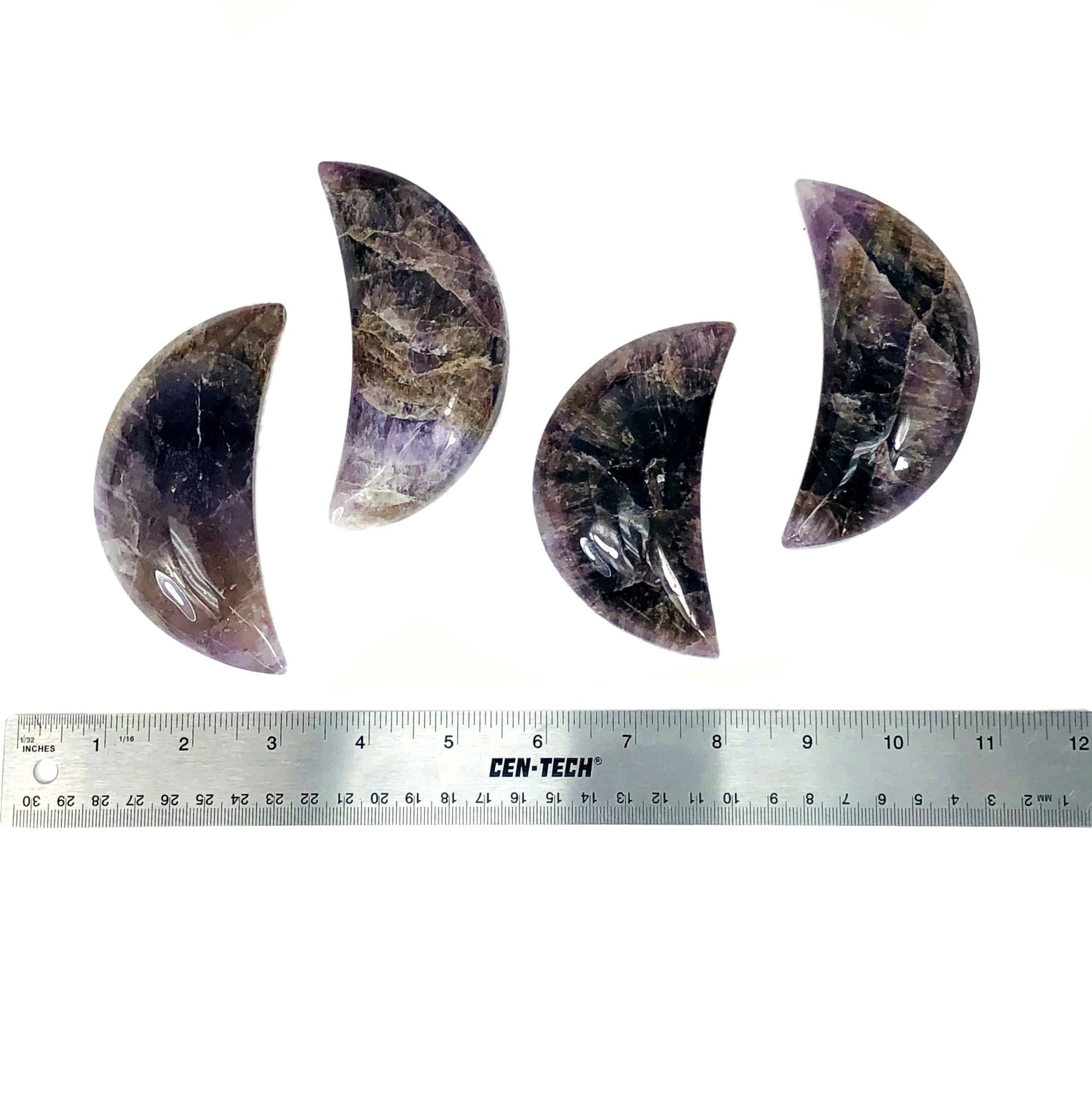 four seven minerals in one polished moons with ruler for size reference