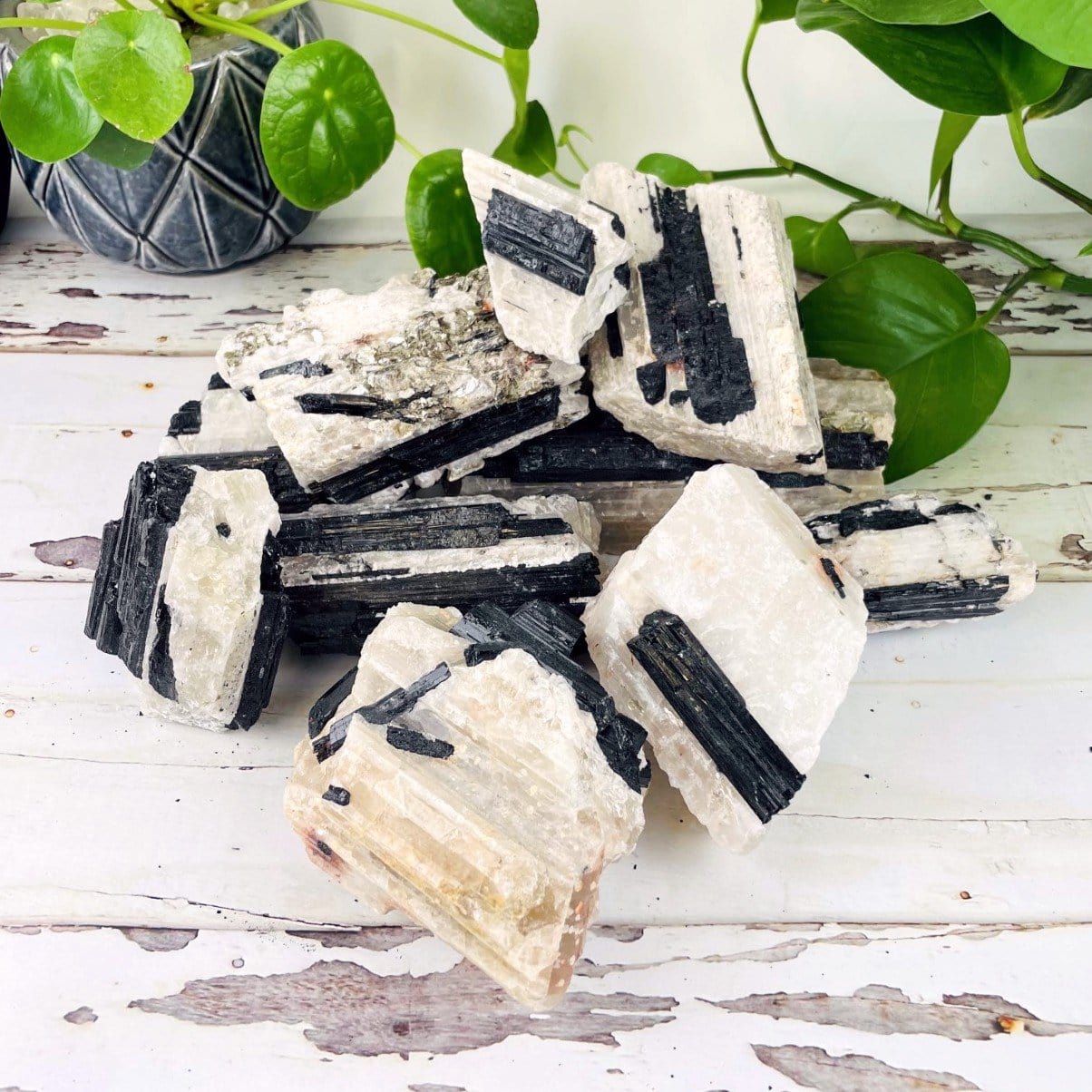 a pile of black tourmaline on matrix