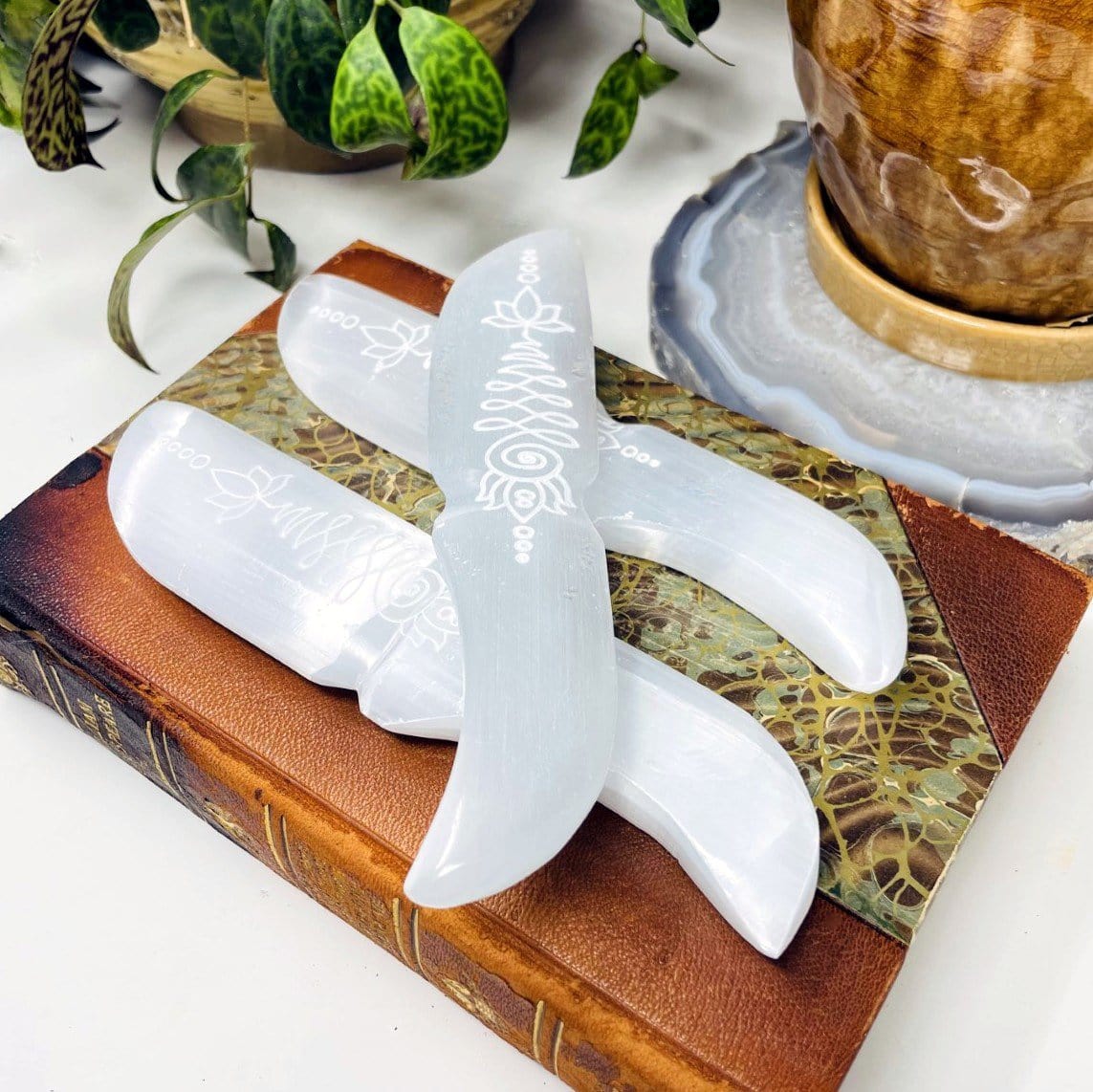 selenite knives with unalome engraving on display for possible variations 