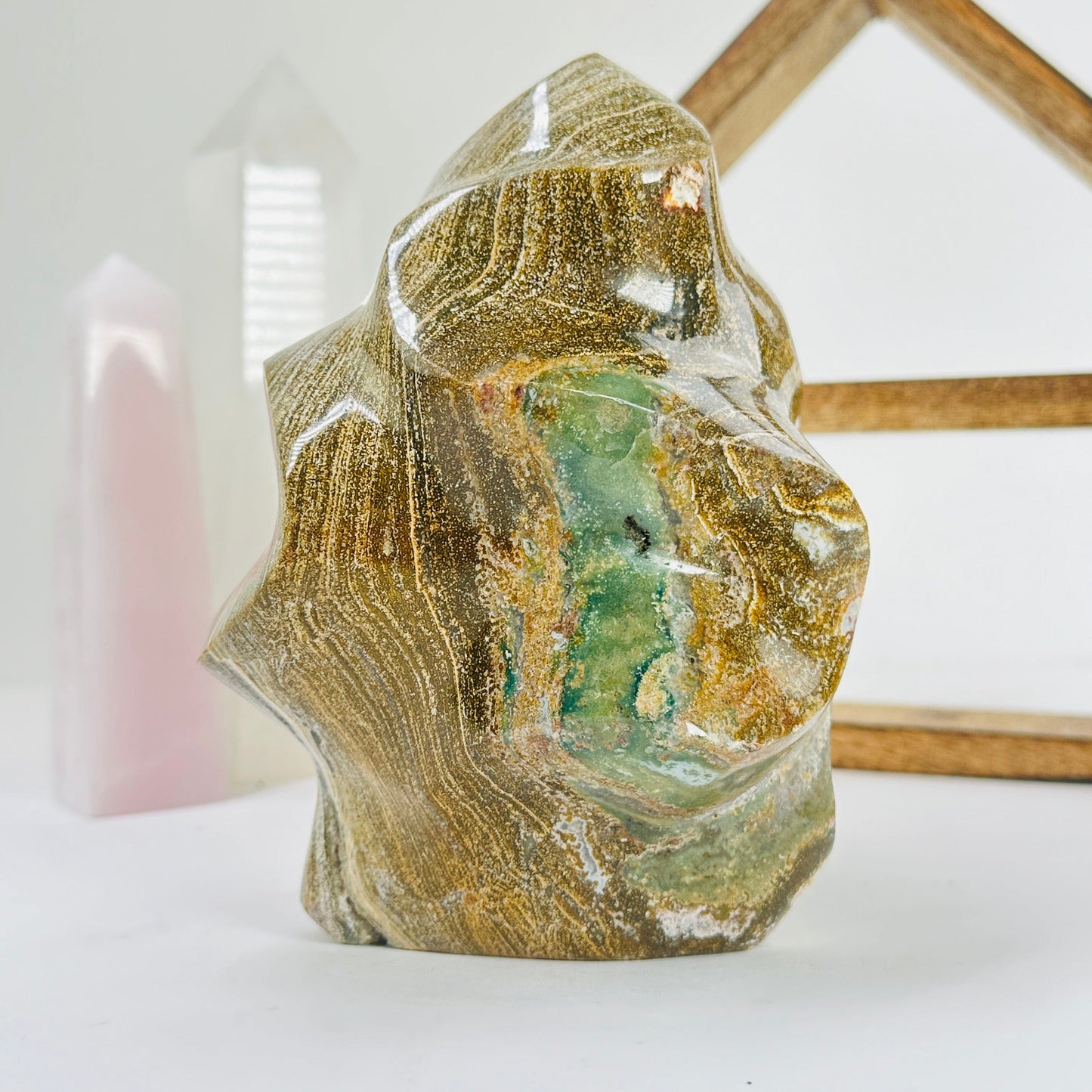 ocean jasper flame point with decorations in the background
