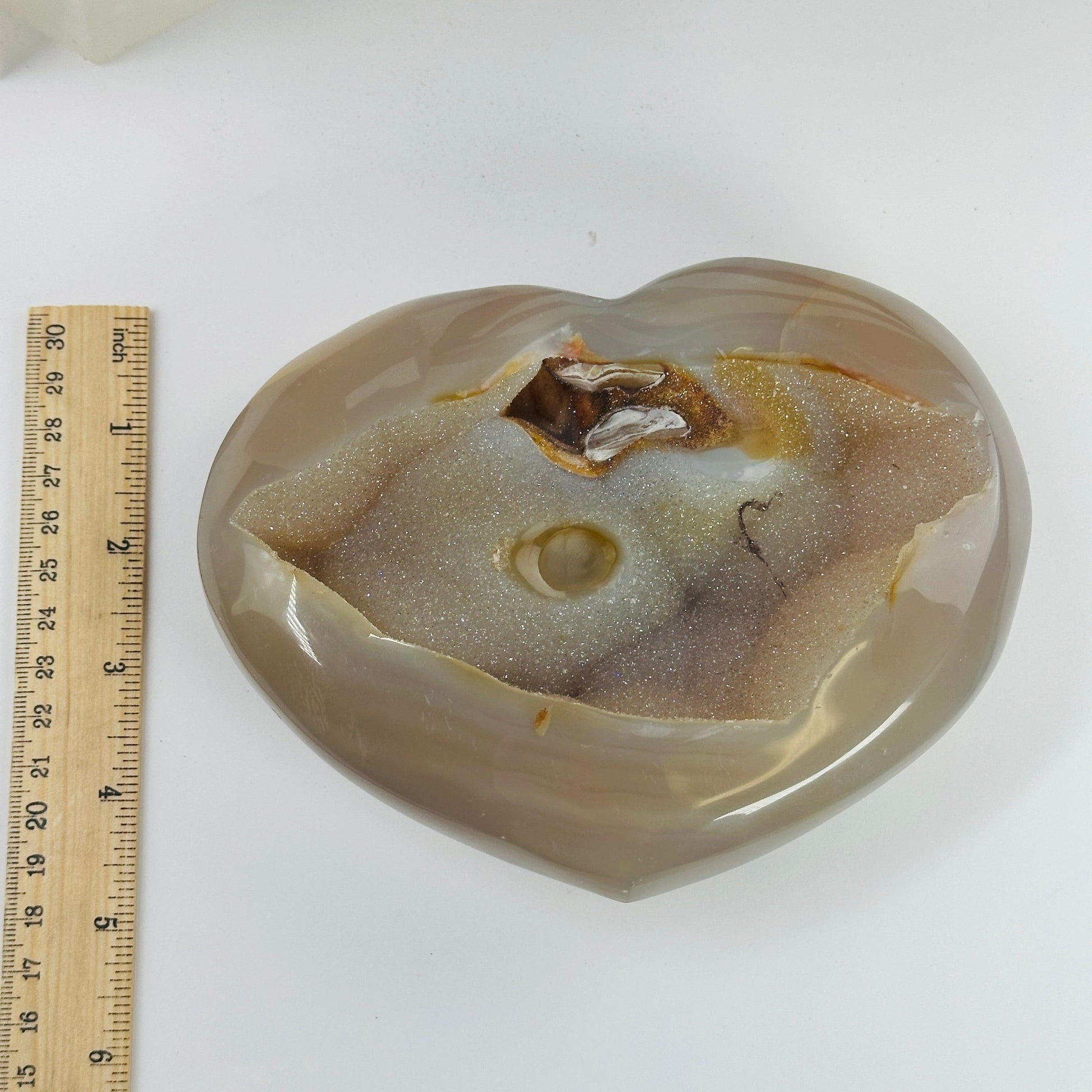 agate heart next to a ruler for size reference