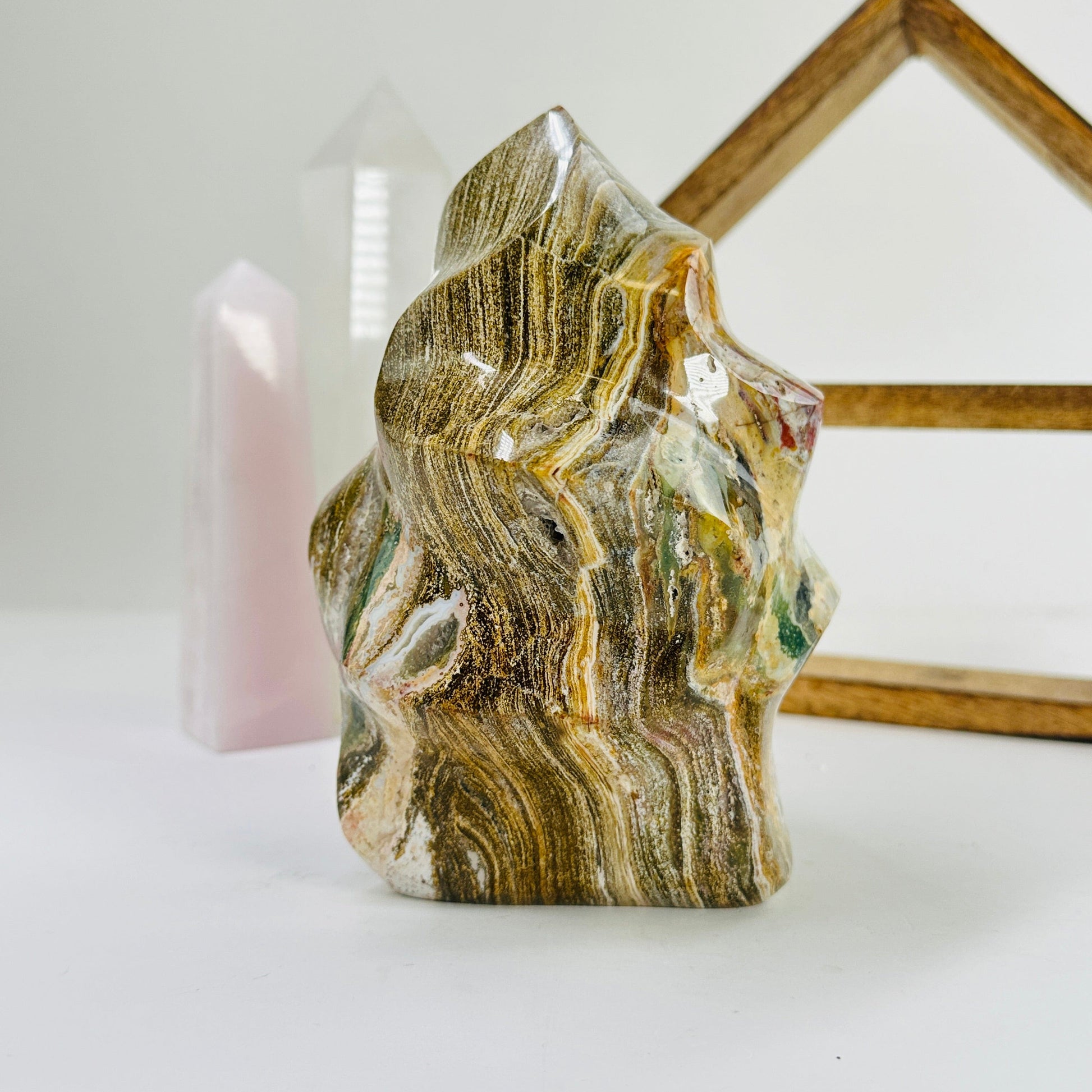 ocean jasper flame point with decorations in the background