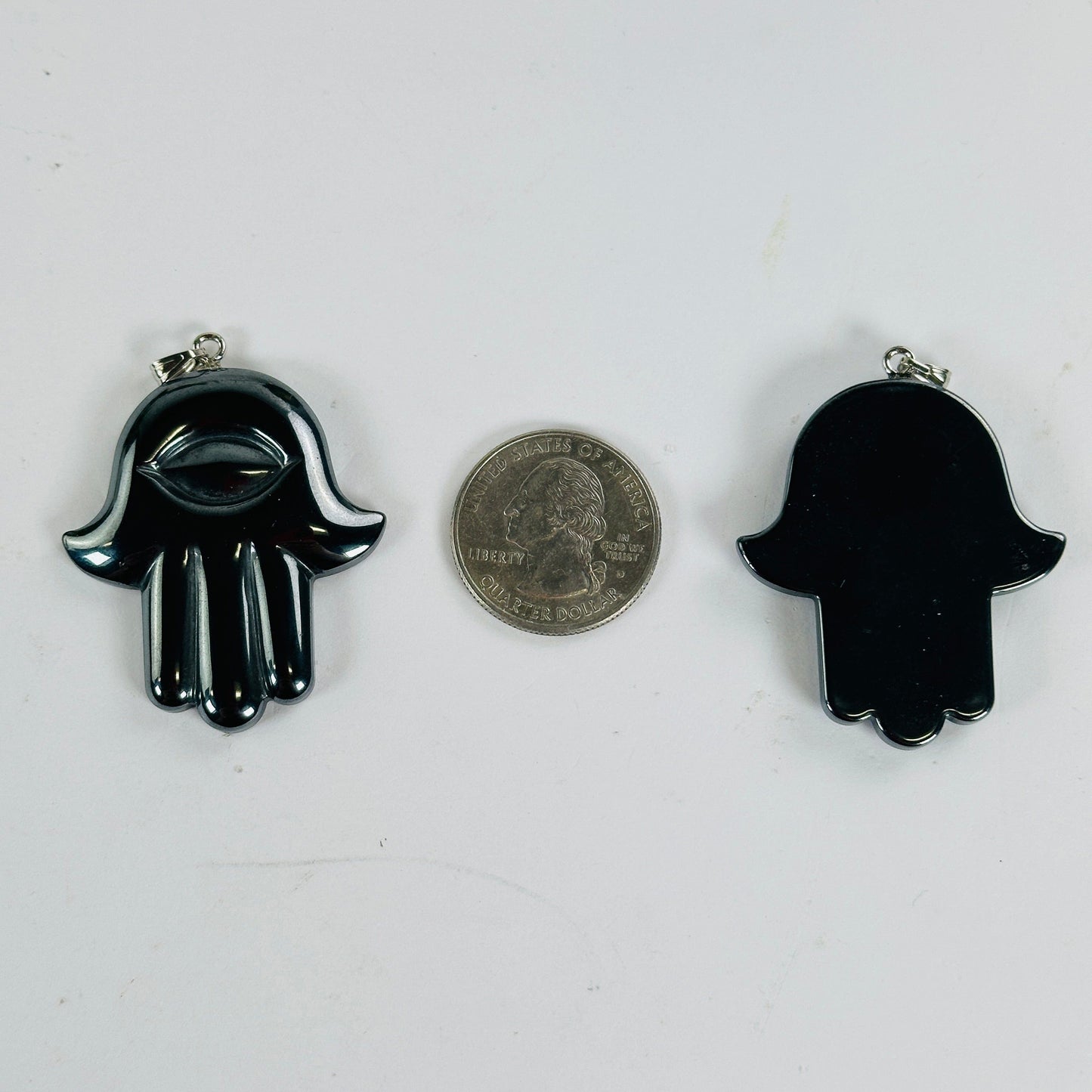 Hematite Hamsa Hand - Hand of Fatima Pendant front and back view with quarter for size reference