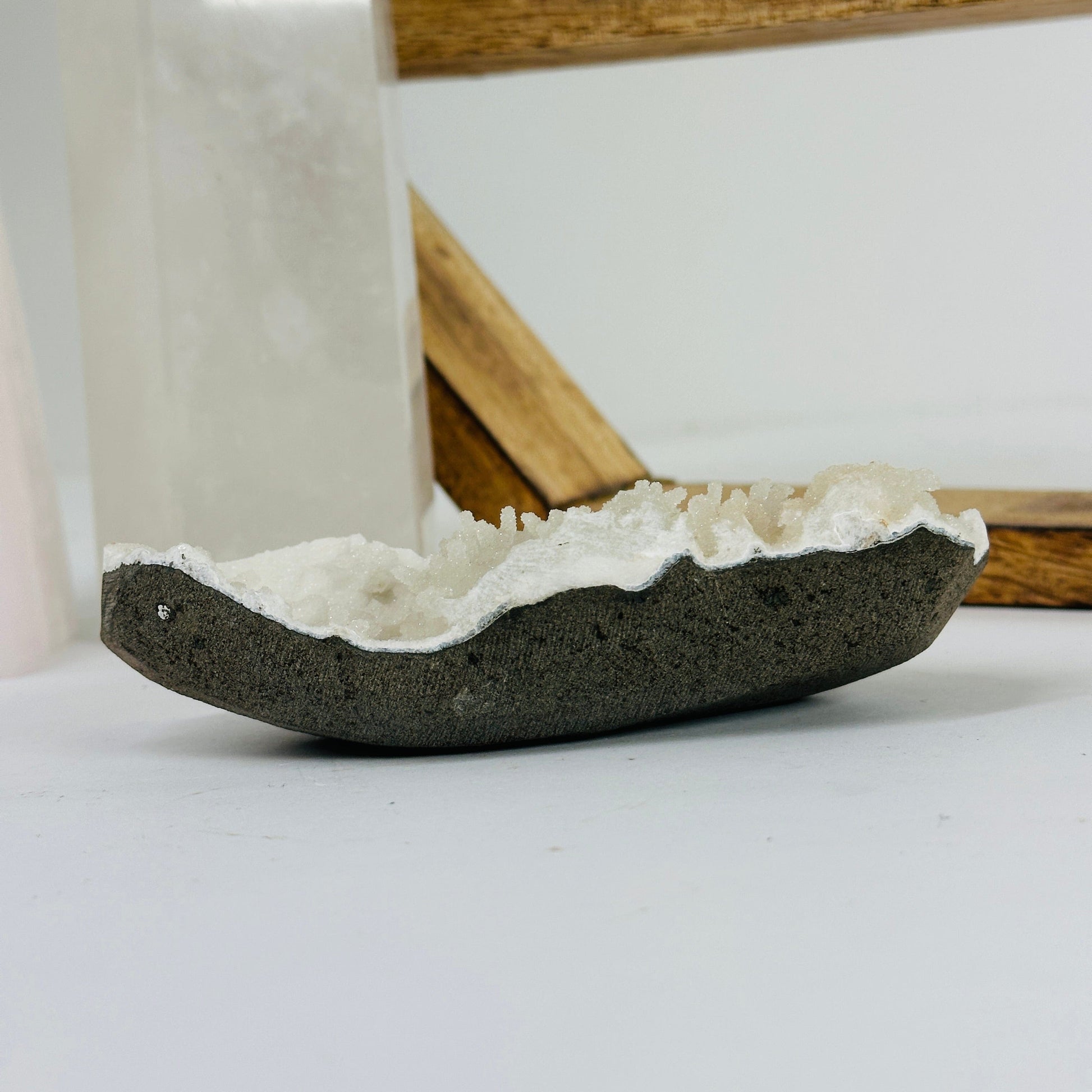 apophyllite on matrix with decorations in the background