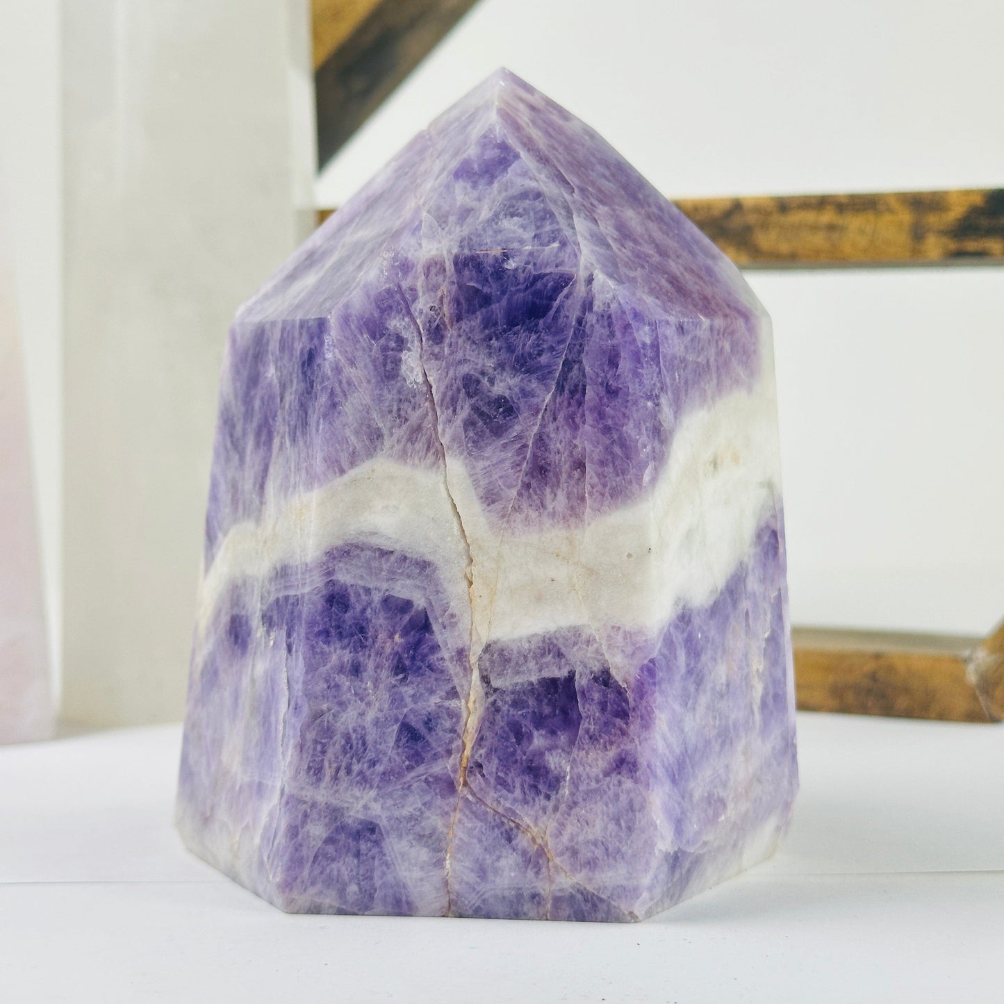 chevron amethyst polished point with decorations in the background