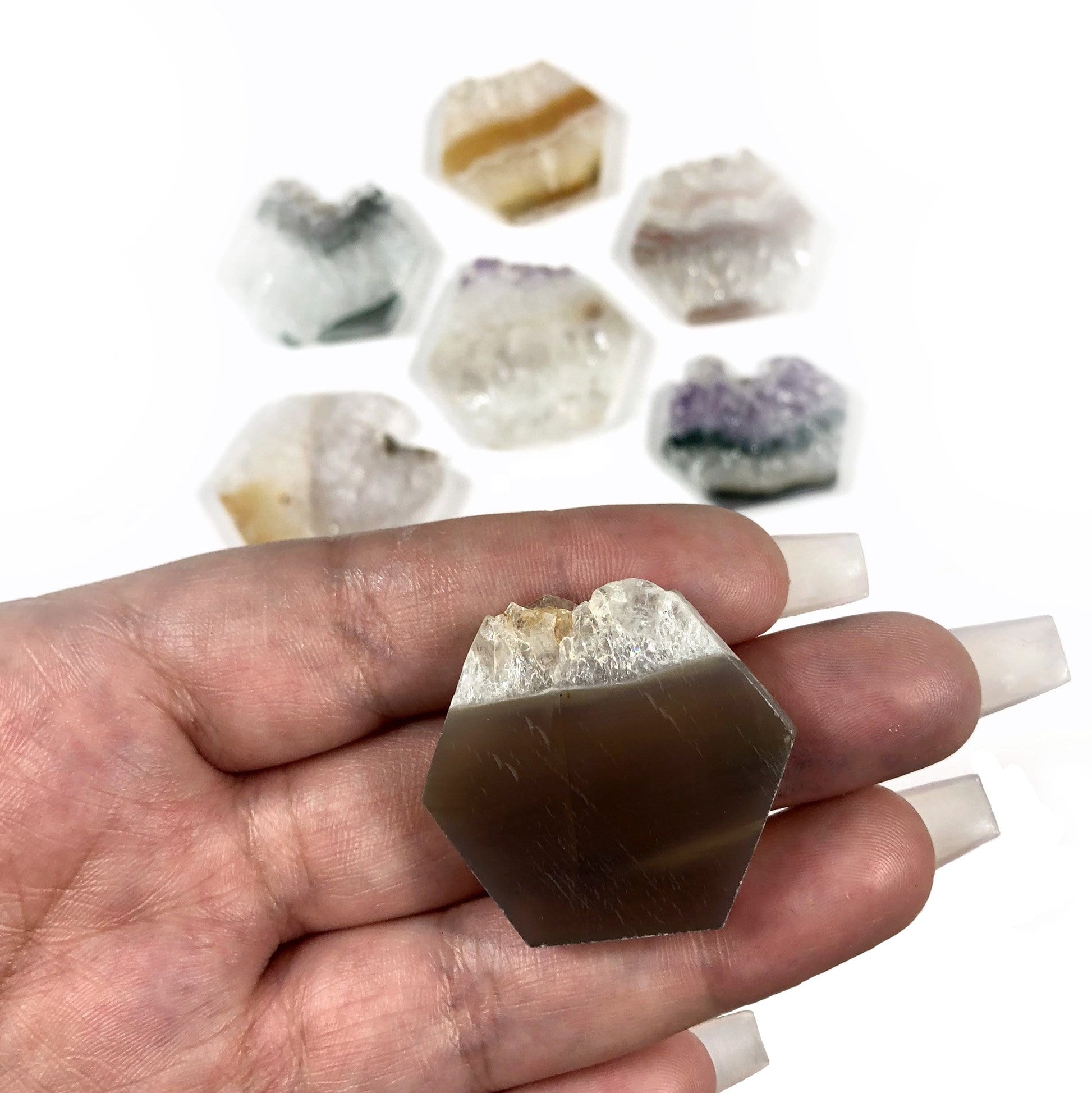 small hexagon displayed in hand for size reference