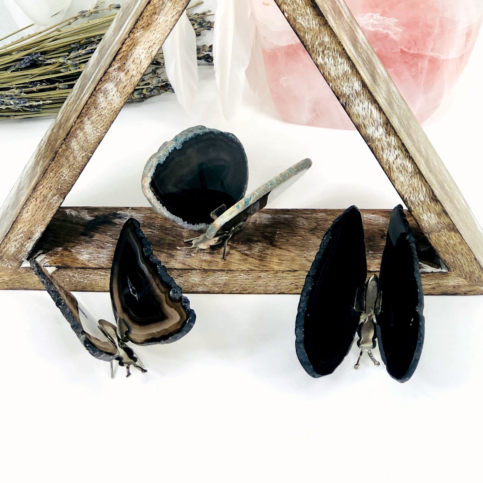 Black Agate Druzy Butterfly Stands in an alter with crystals and flowers.