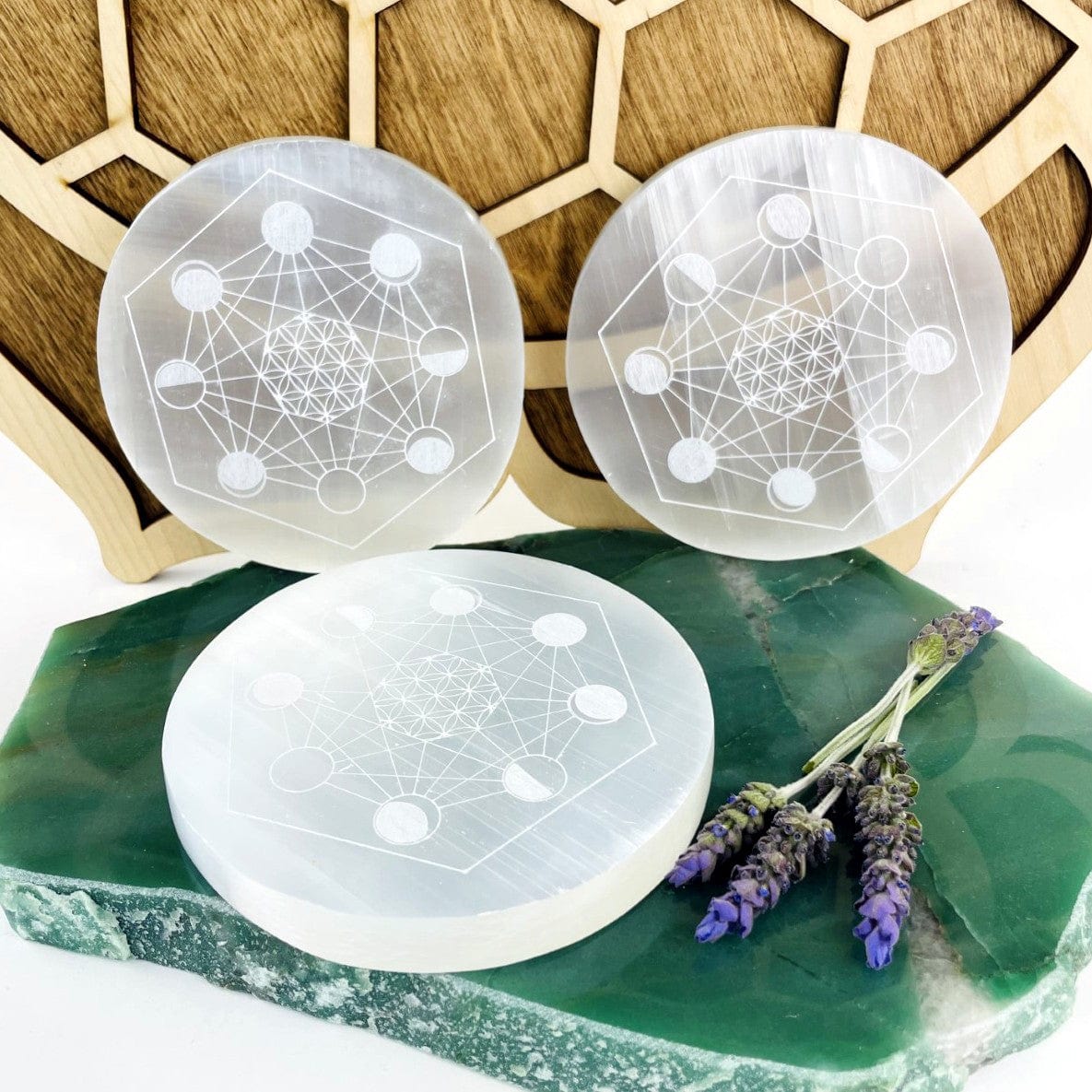 selenite moon phase engraved charging plates on display for detail variations