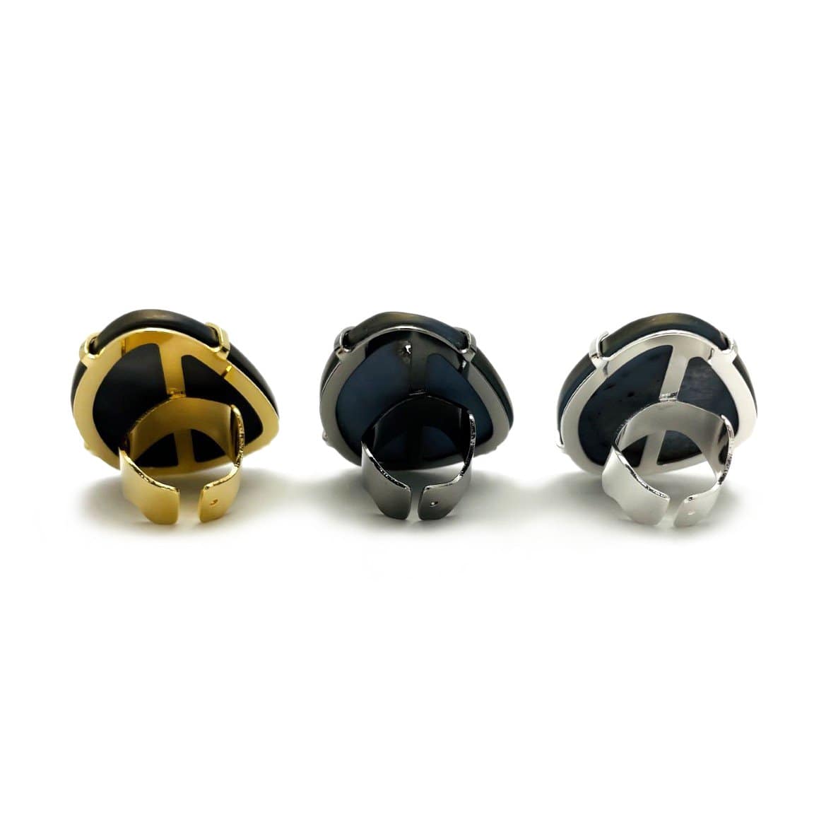 Backside view of three black druzy rings on a white background.