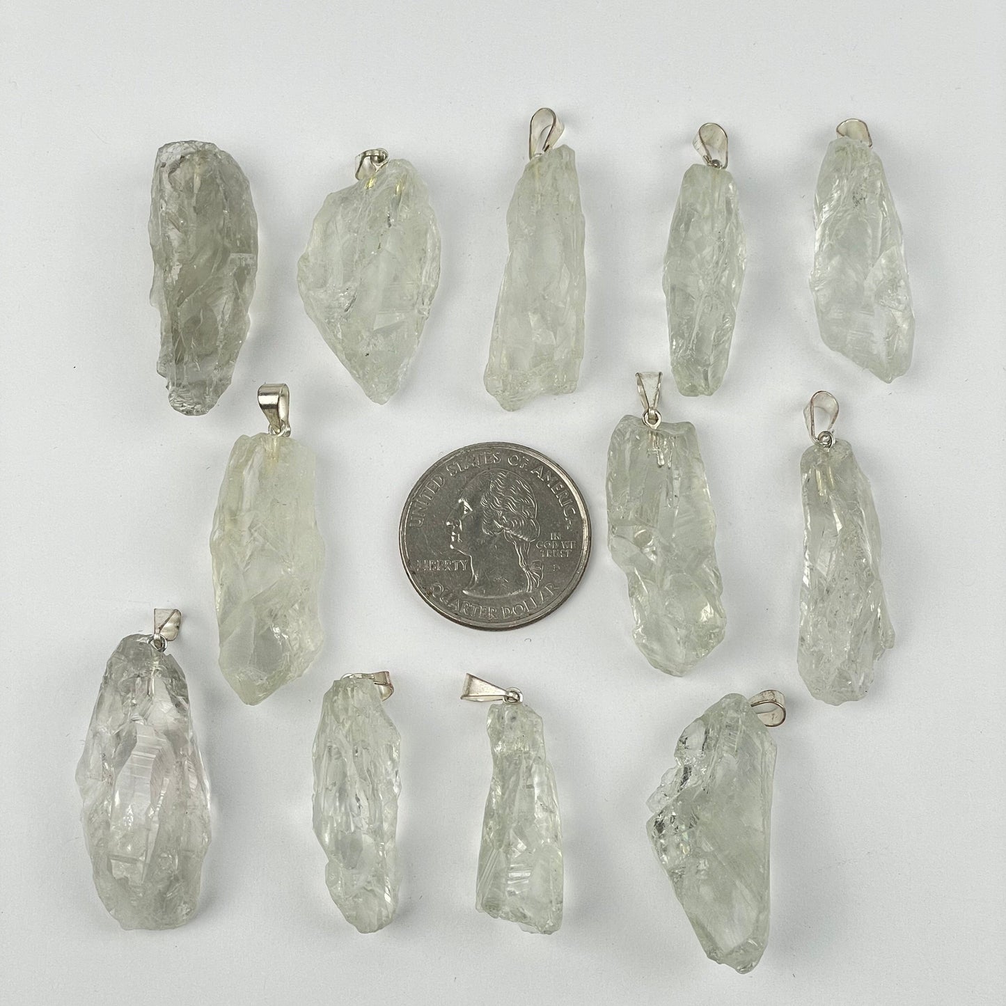pendants next to a quarter for size reference 
