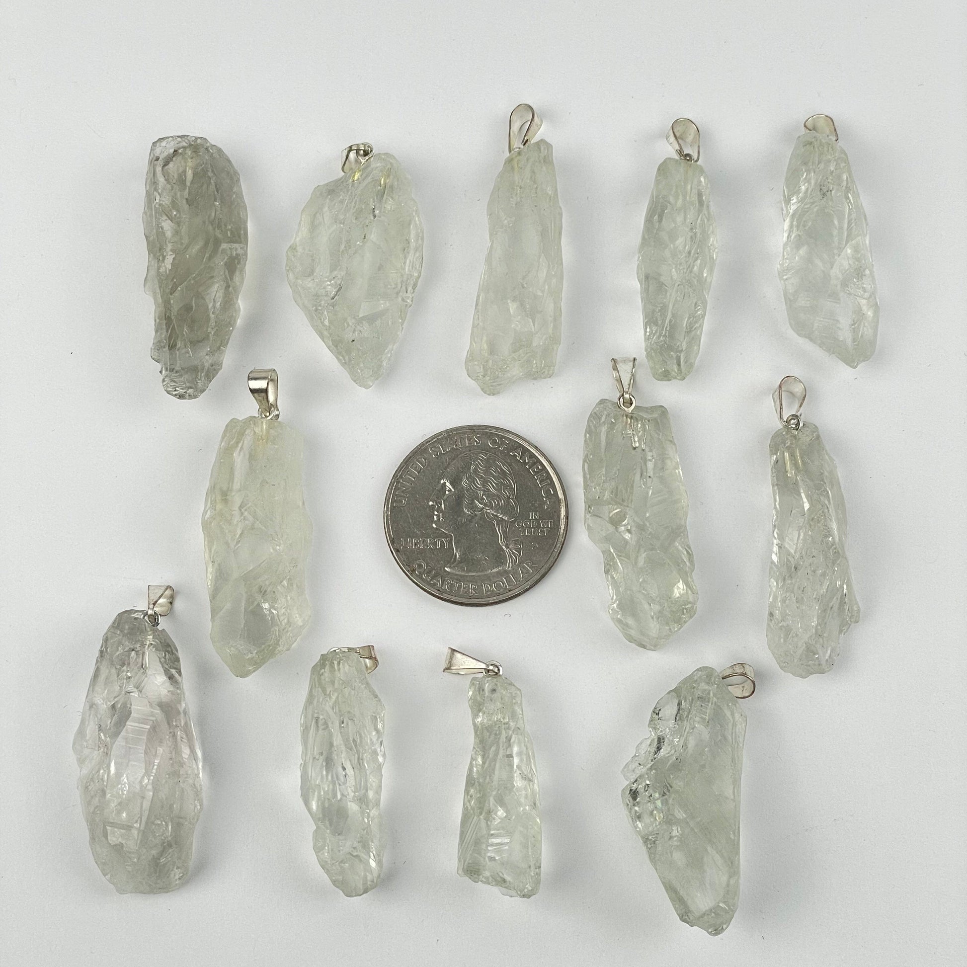 pendants next to a quarter for size reference 