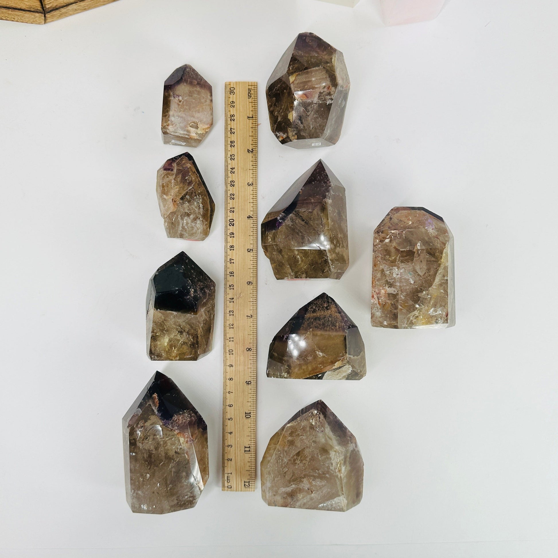 ametrine polished points next to a ruler for size reference