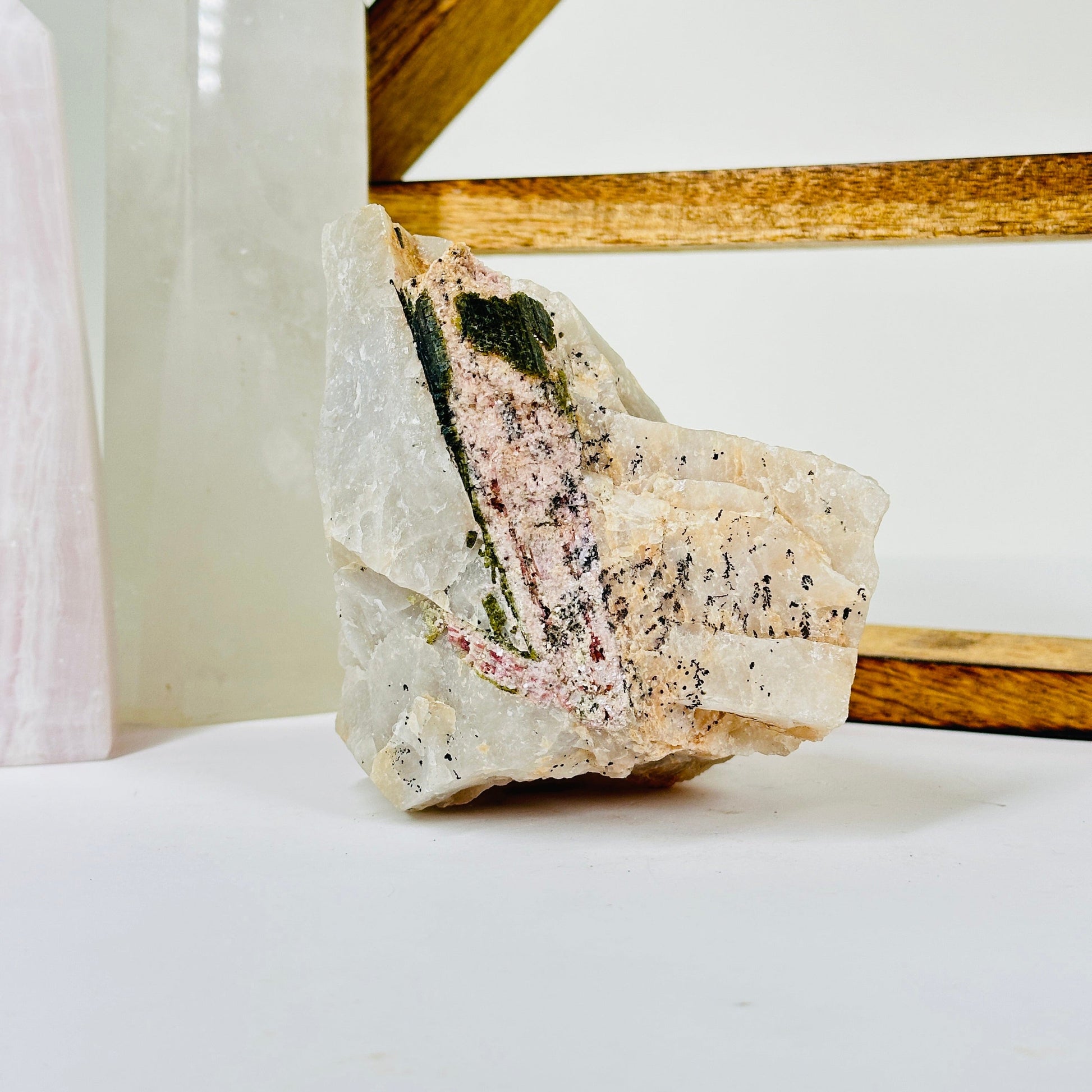 watermelon tourmaline with decorations in the background