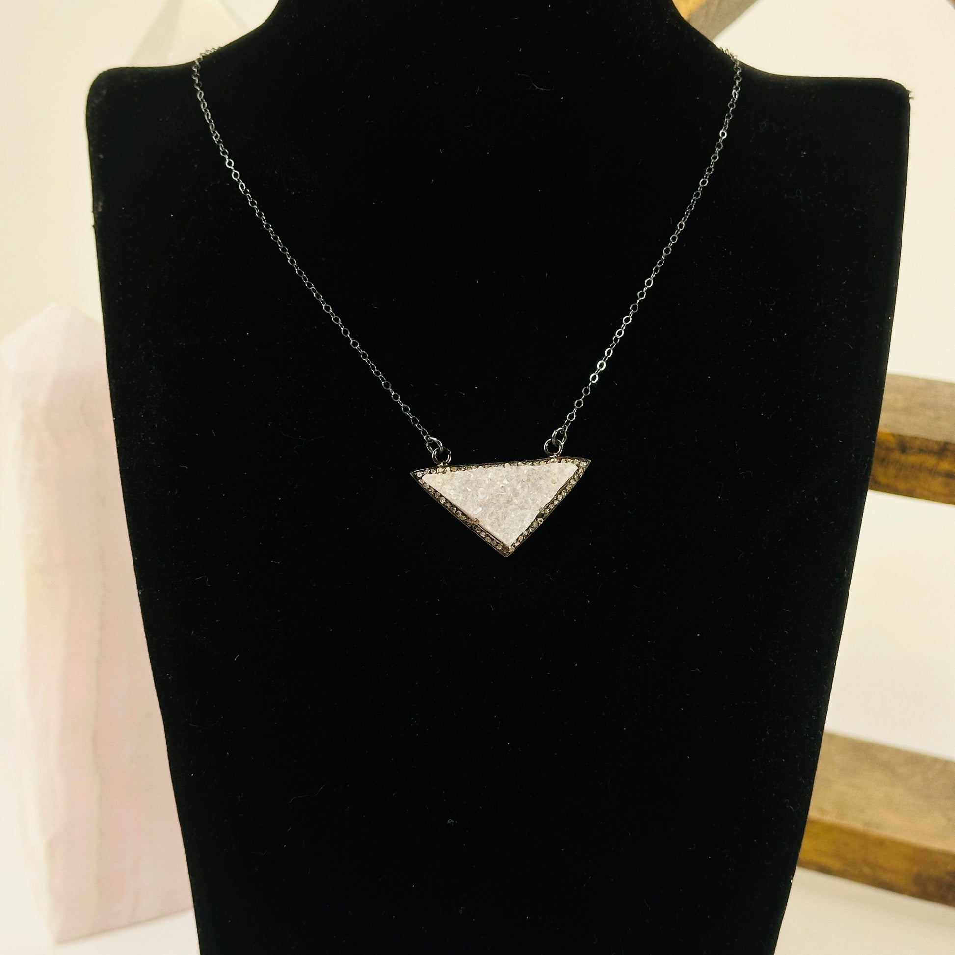 druzy pendant necklace with decorations in the background