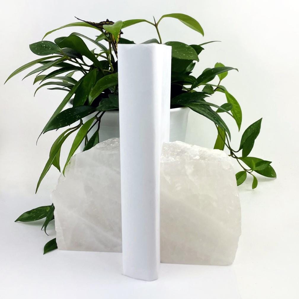 Crystal quartz bookend with a white book between them.
