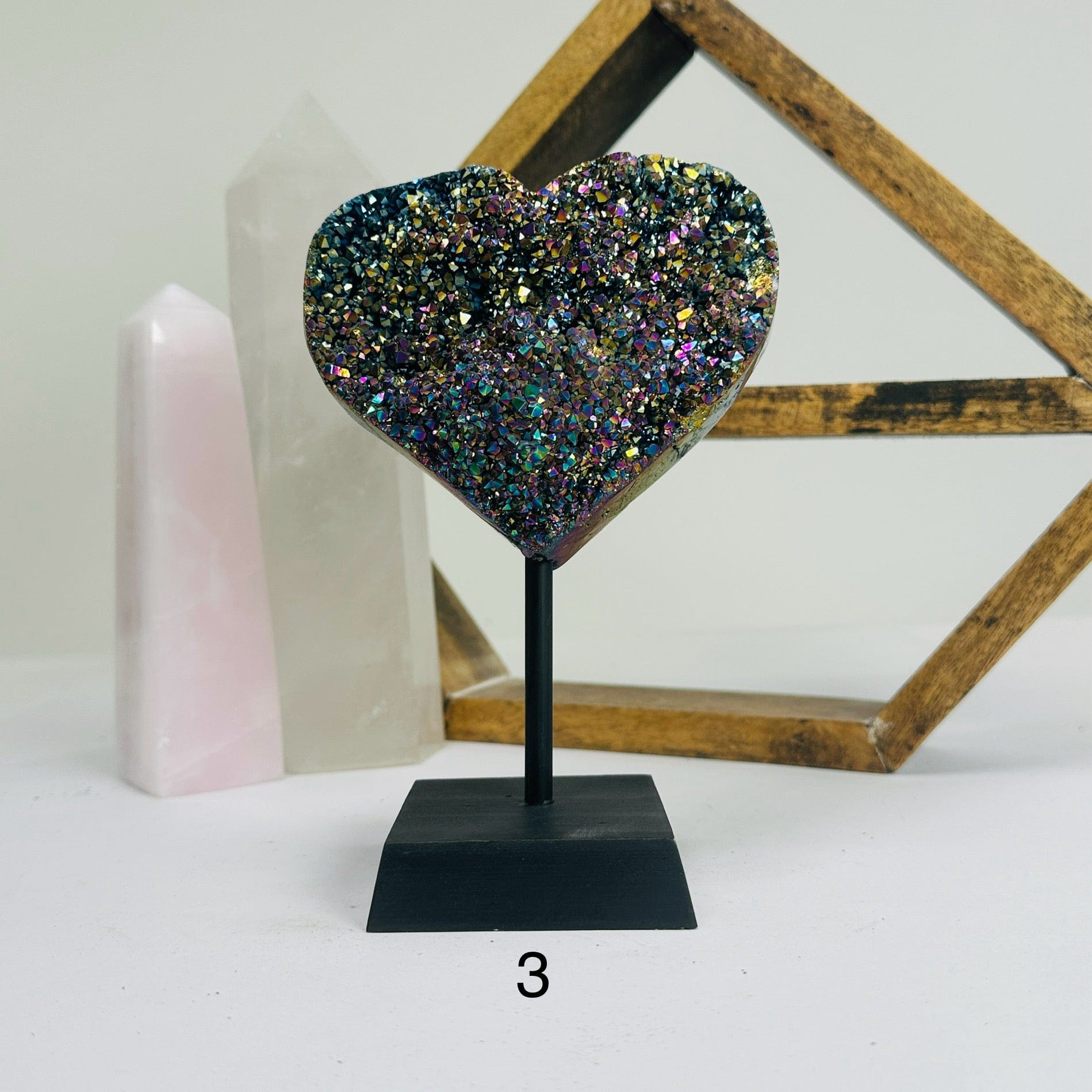 titanium coated heart on stand with decorations in the background