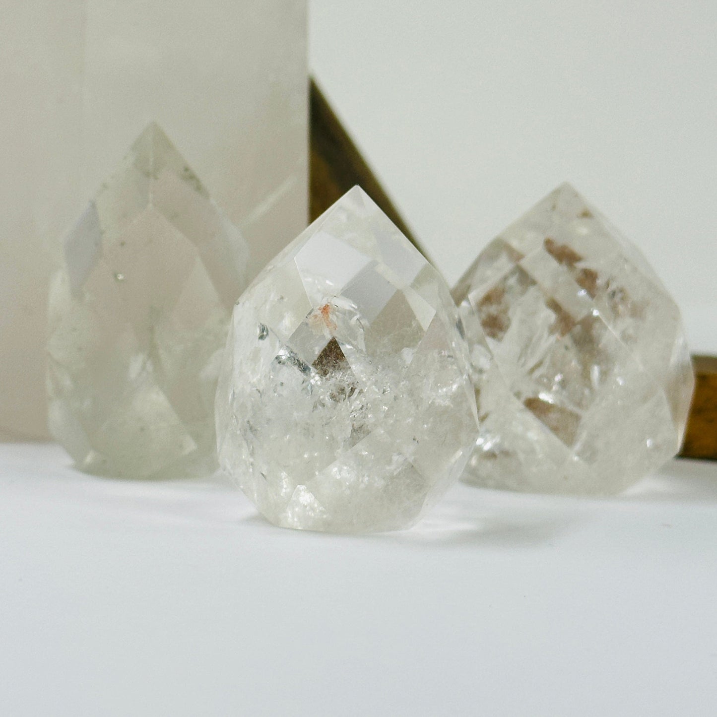 crystal quartz point with decorations in the background