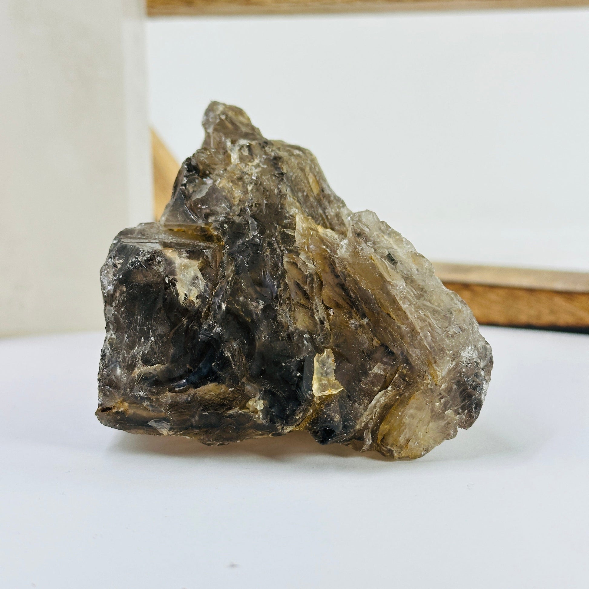 smoky quartz cluster with decorations in the background
