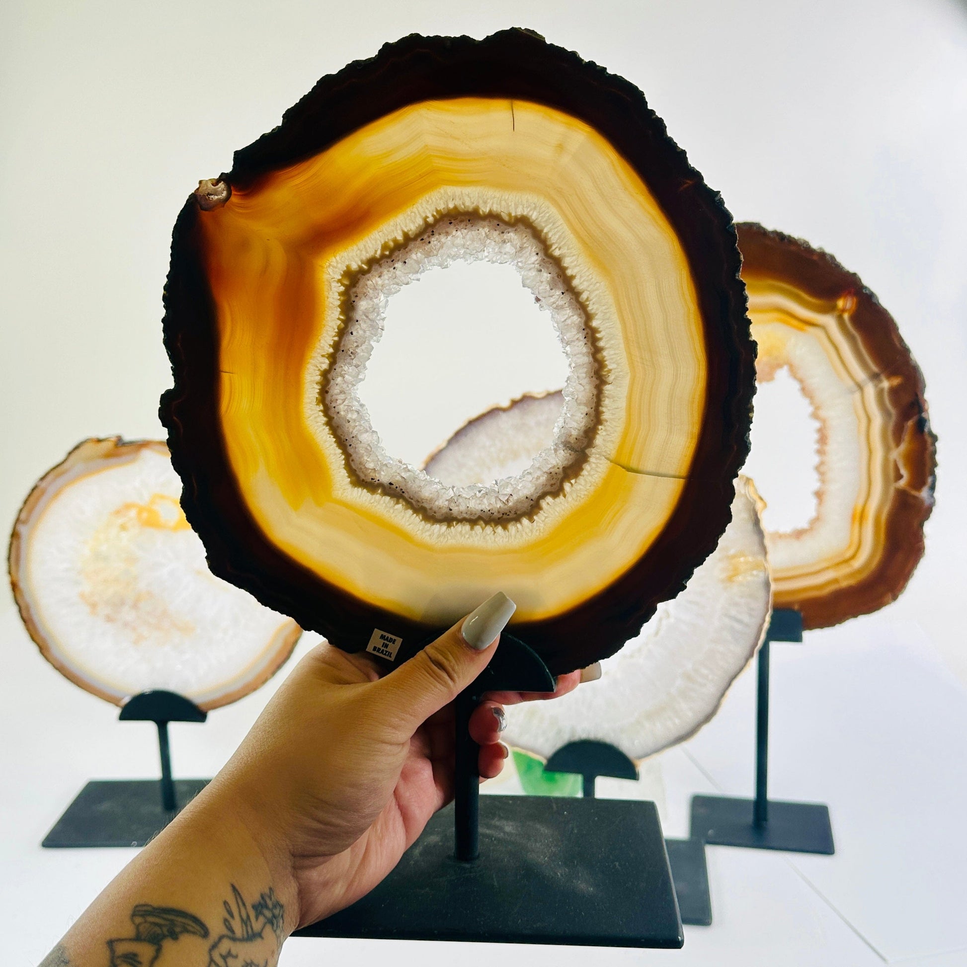 Agate Crystal Slice on Metal Stand - You Choose variant B in hand for size reference with other variants in the background