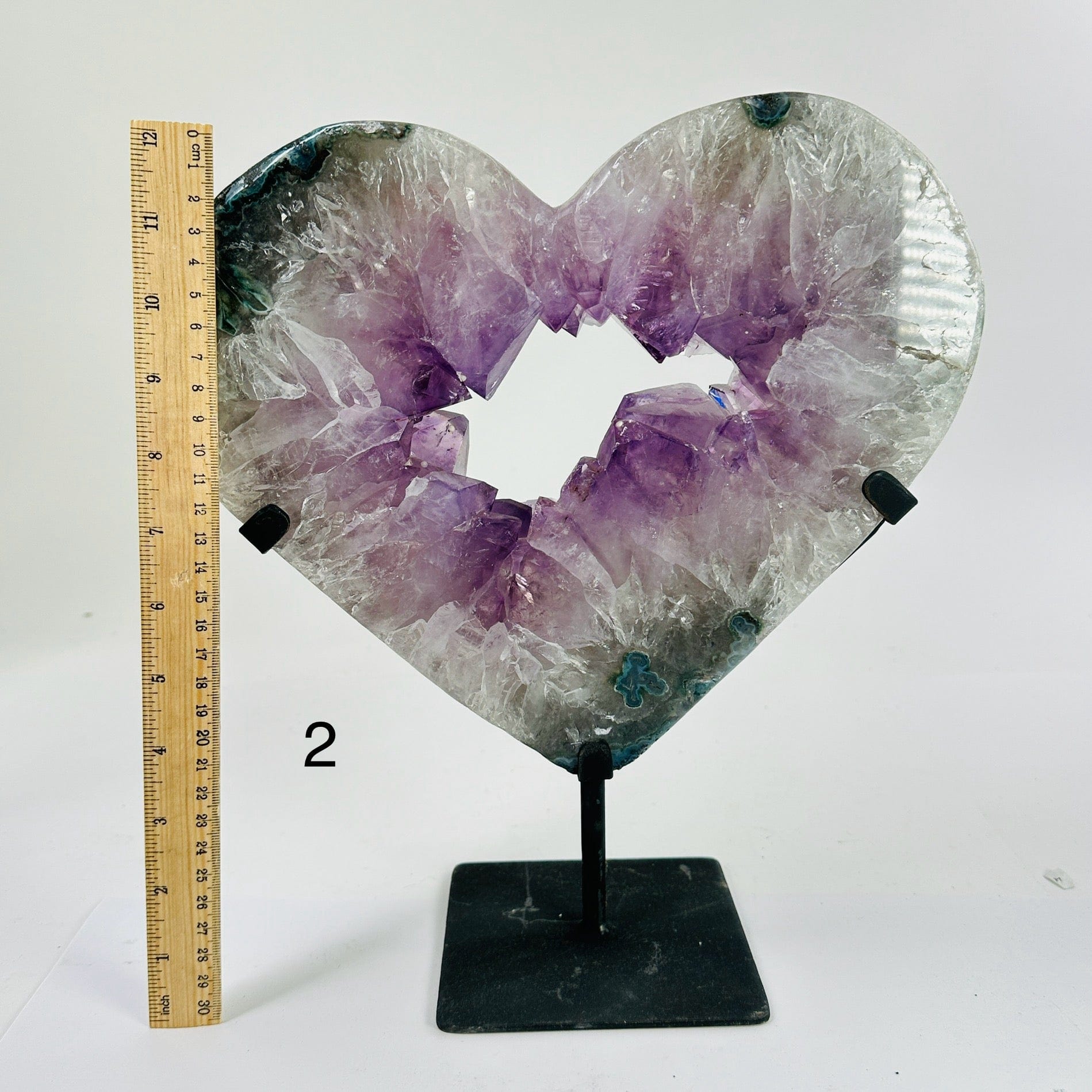 amethyst heart on stand next to a ruler for size reference