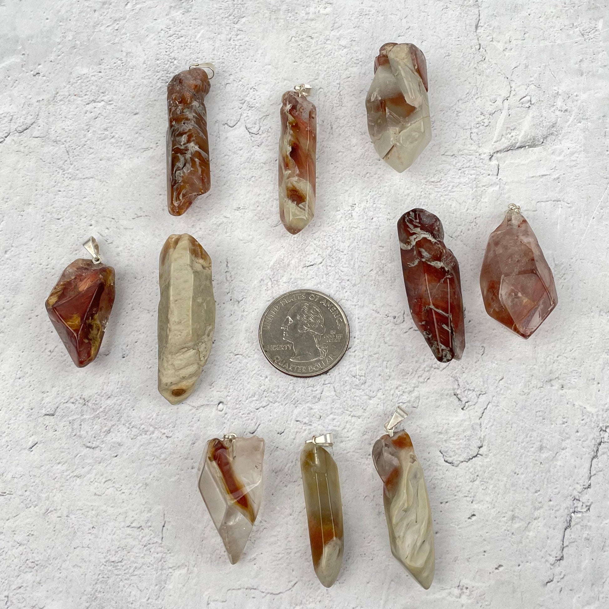 pendants next to a quarter for size reference 