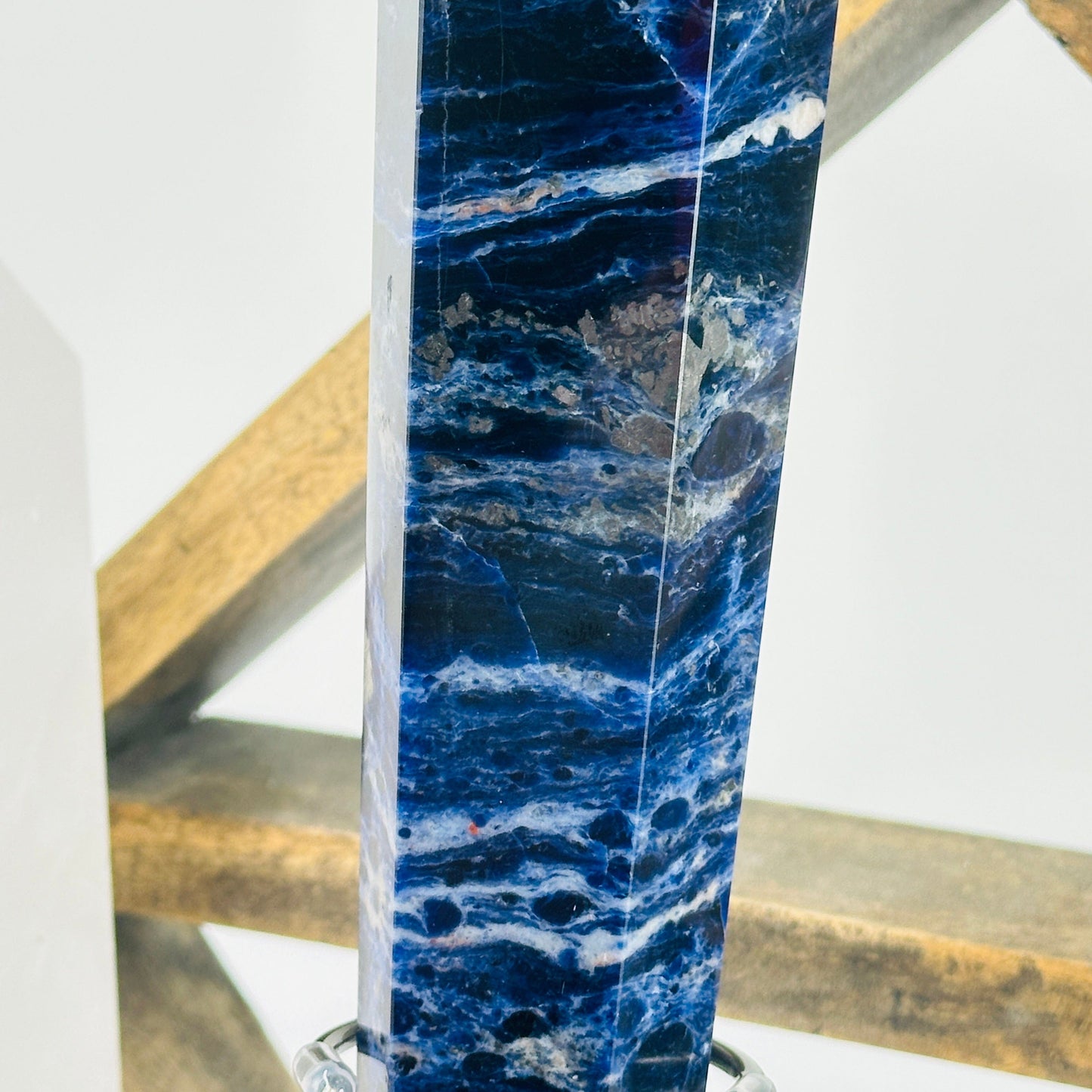 sodalite point with decorations in the background