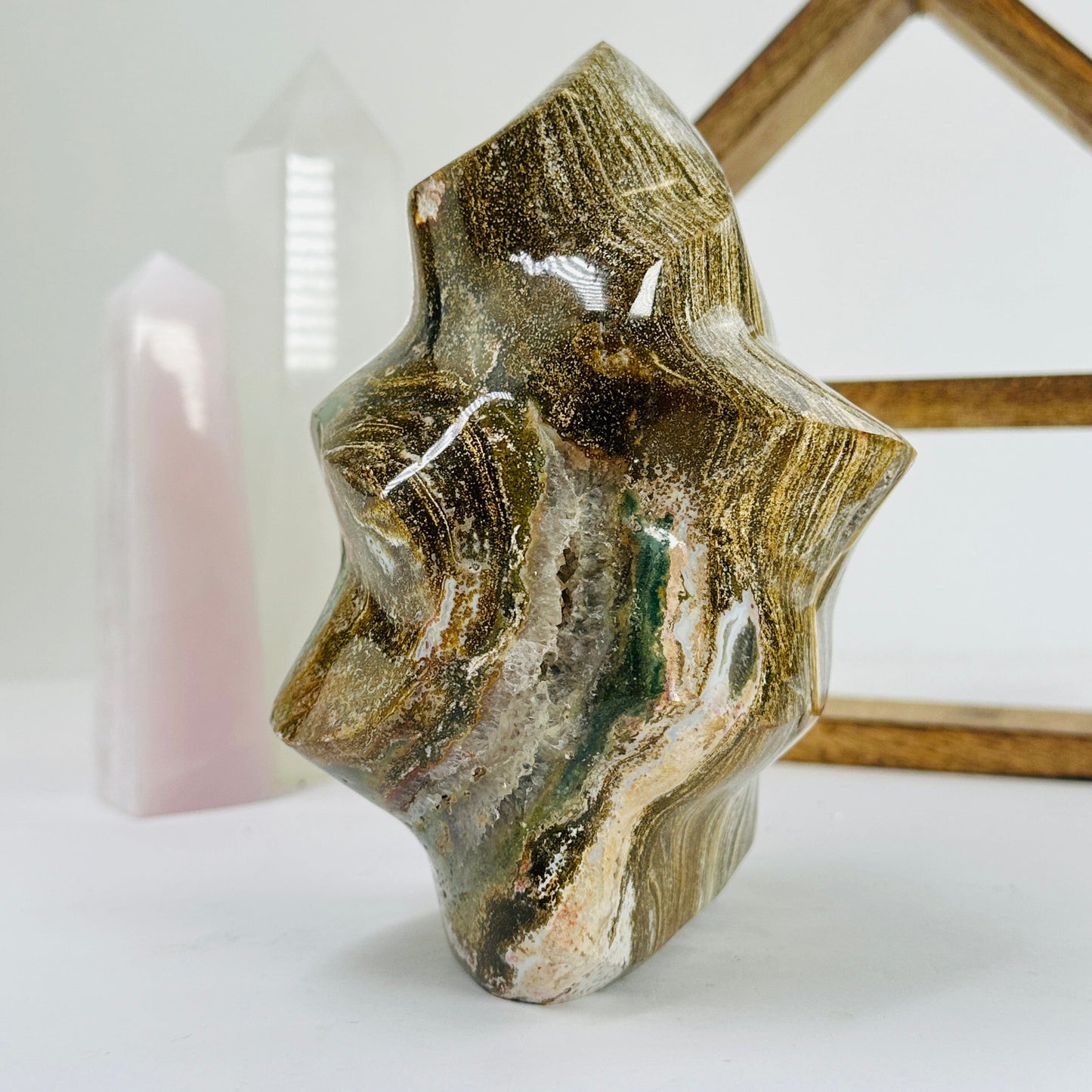 ocean jasper flame point with decorations in the background
