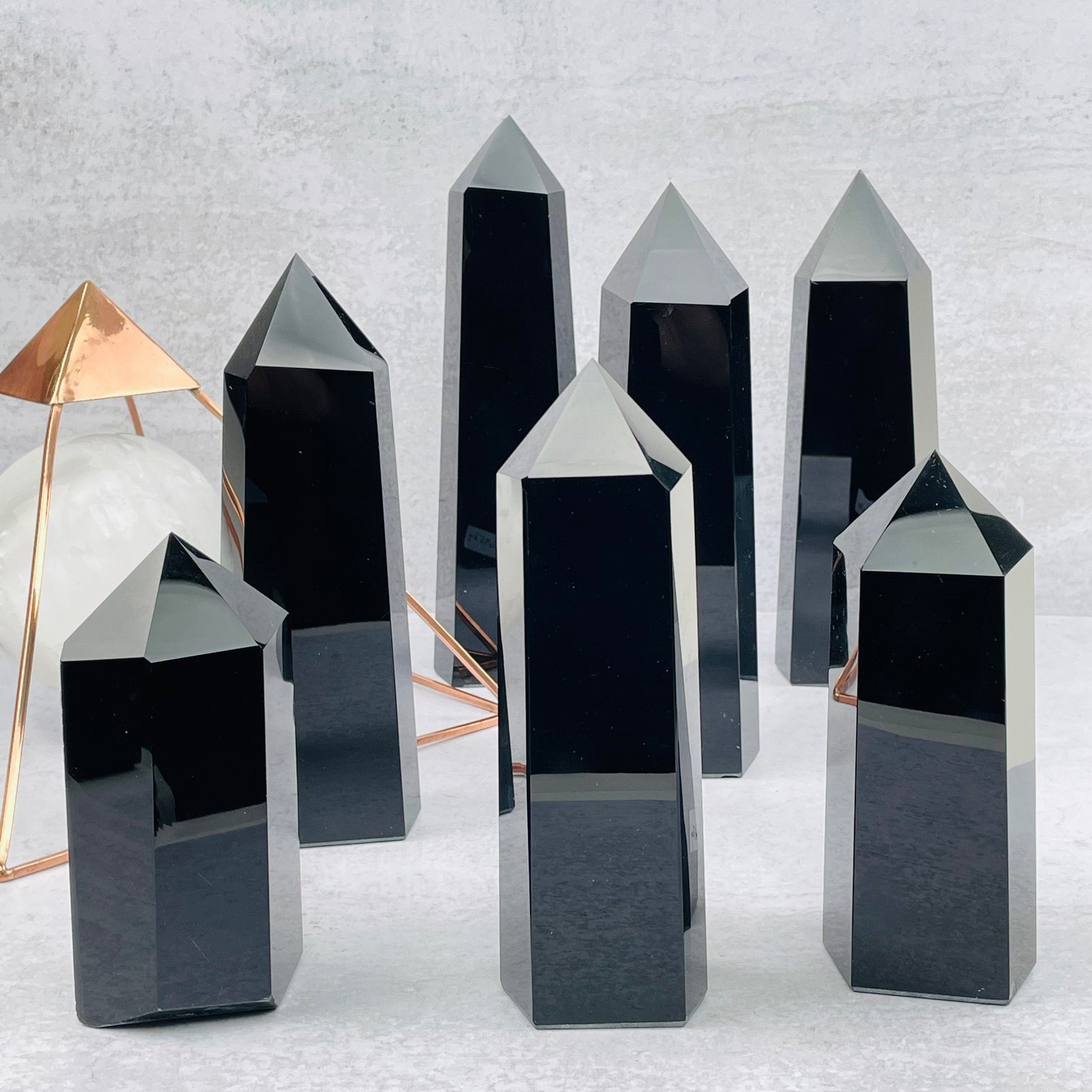 multiple black obsidian points displayed to show the differences in the sizes available