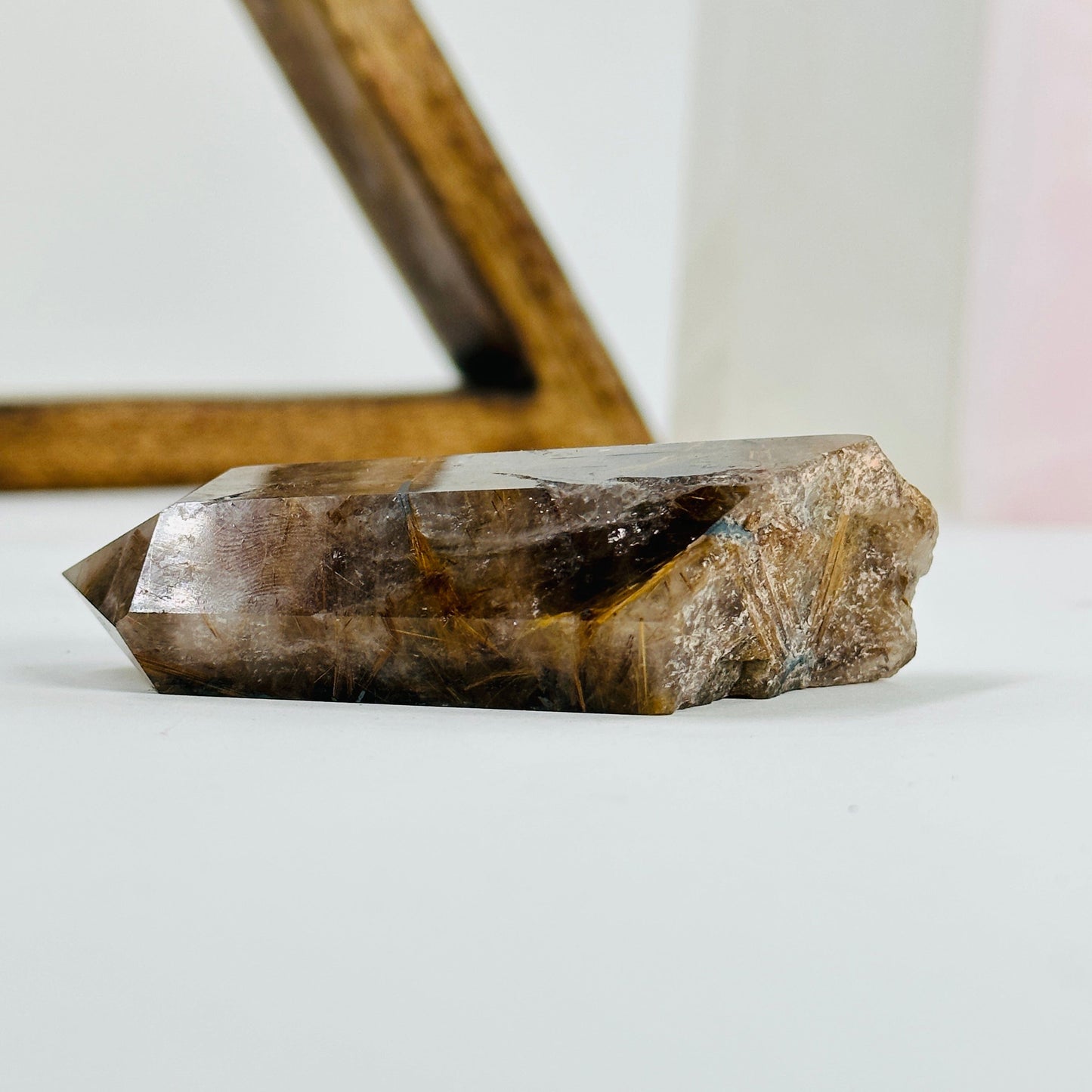 rutilated quartz with decorations in the background