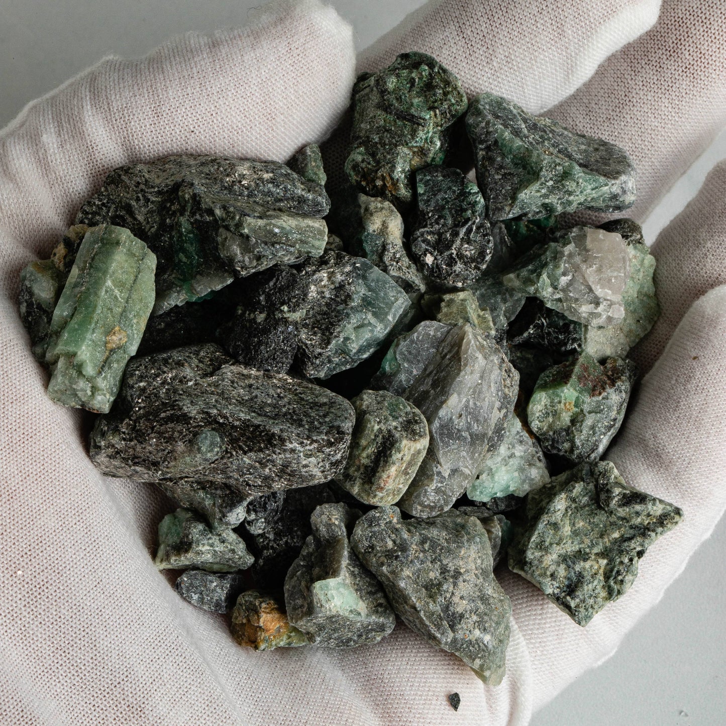 Emerald Stones up close in a hand