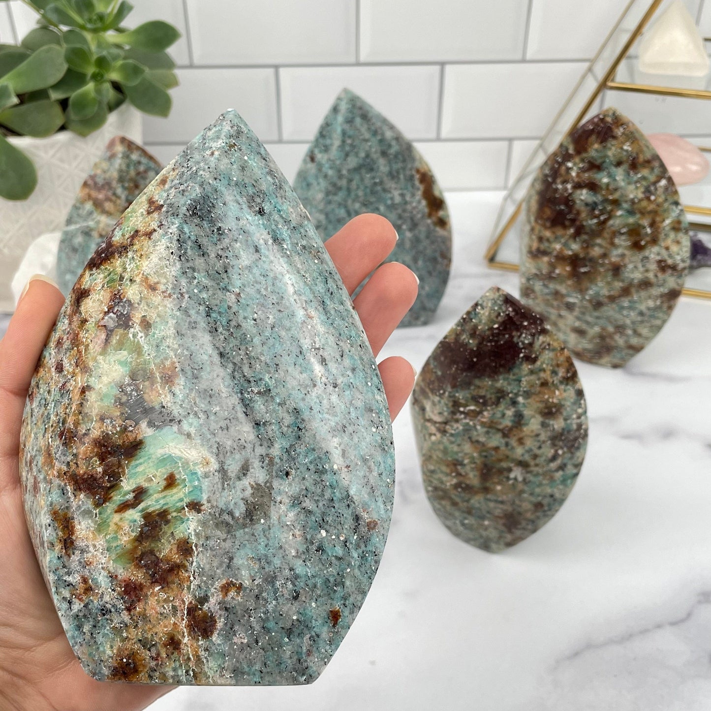 Amazonite Flame Polished Point in hand for size reference 