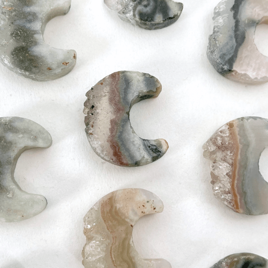 up close shot of amethyst moon crescents on white background