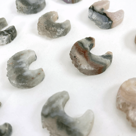 up close shot of amethyst moon crescents on white background