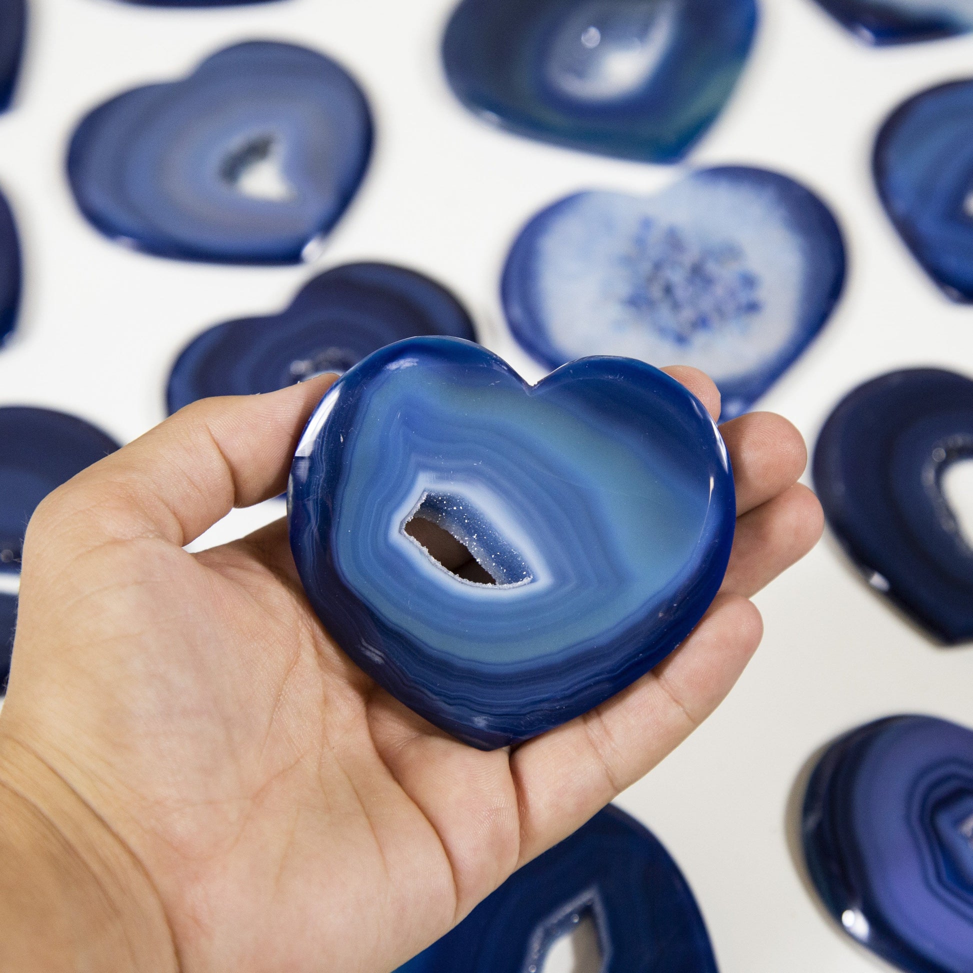blue heart displayed in hand for size reference