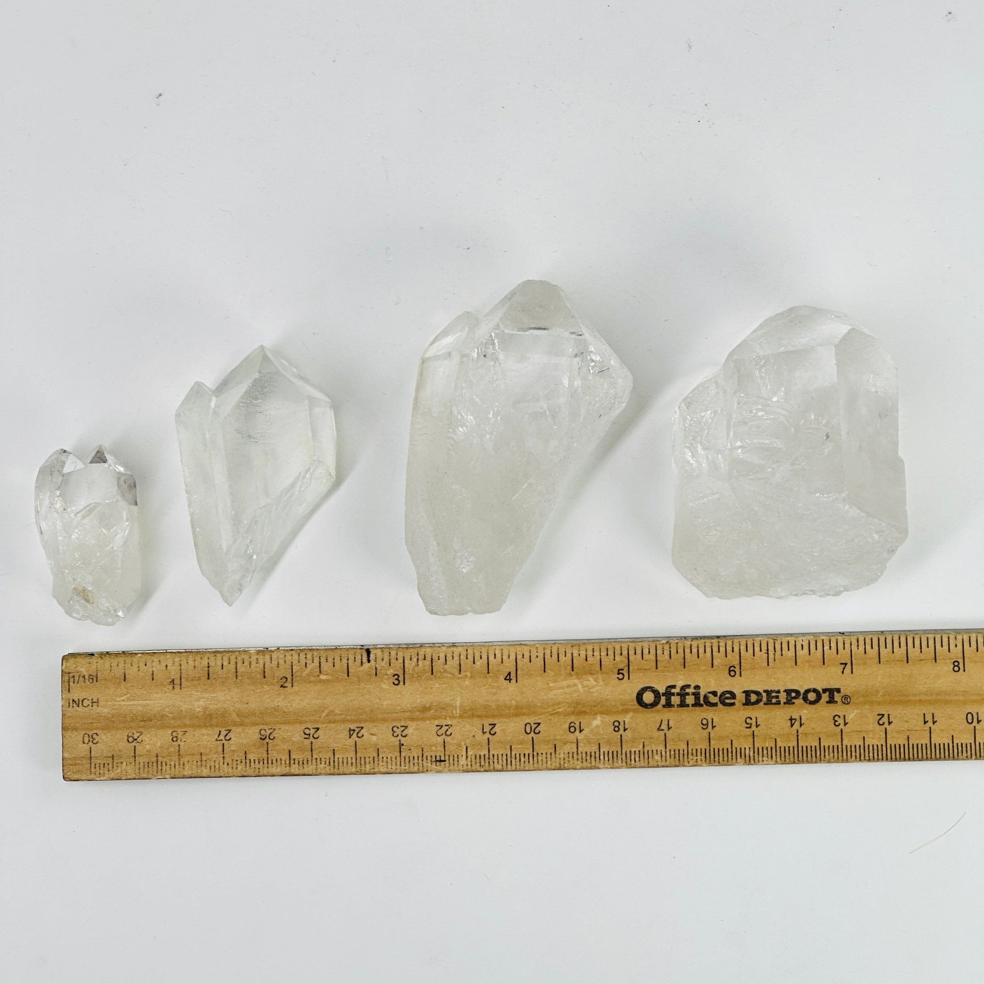 crystal quartz points next to a ruler for size reference