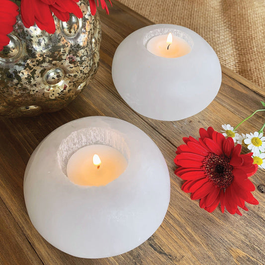 2 Selenite Sphere Candle Holders on display with lit candles inside