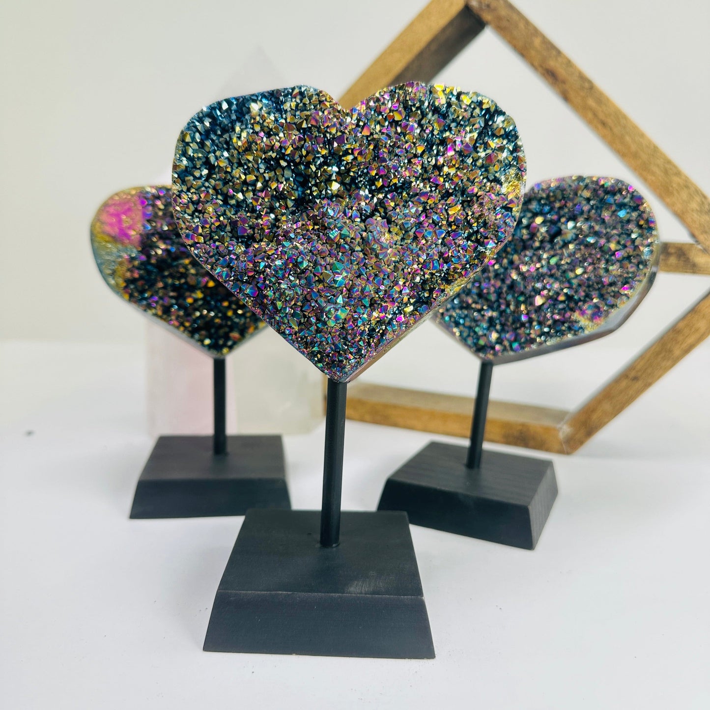 titanium coated heart on stand with decorations in the background